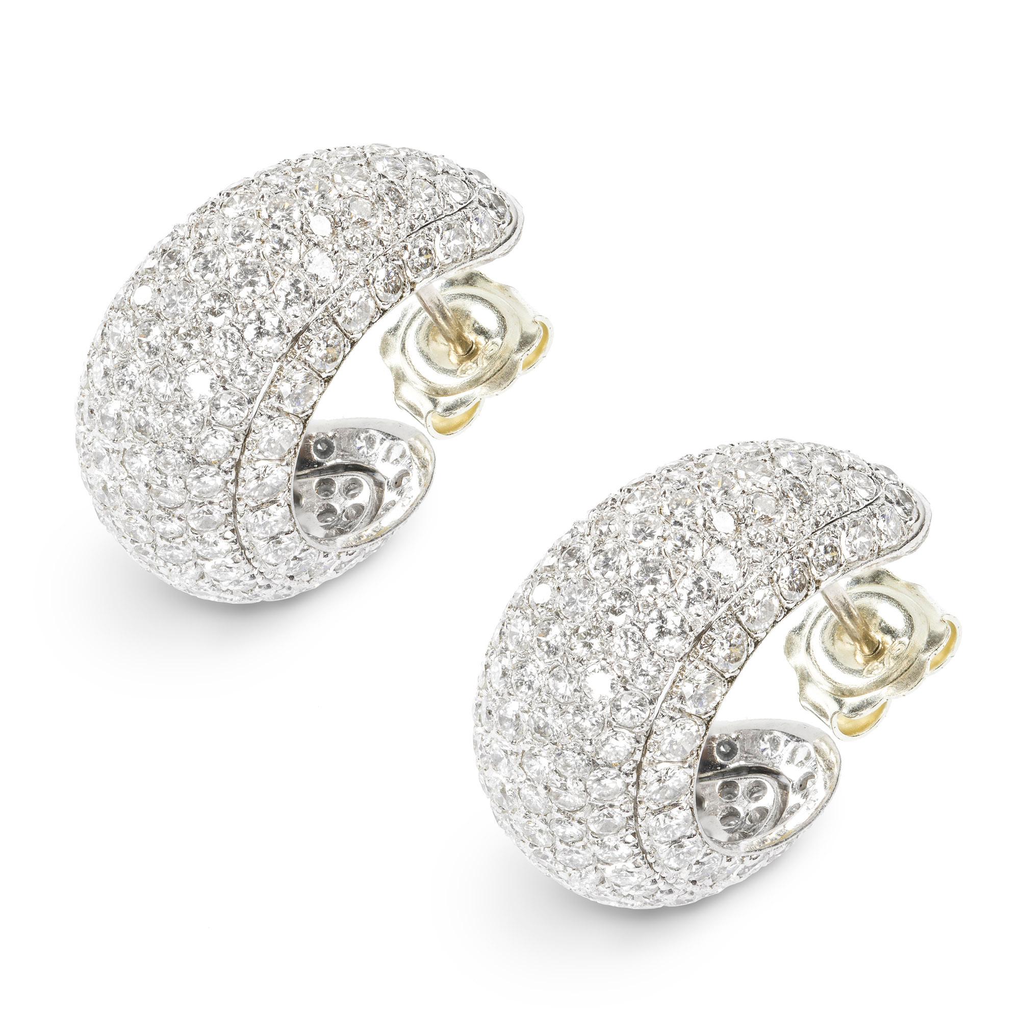 A pair of diamond set half hoop earrings, the diamond bombé style half hoop earrings, estimated to weigh a total of 9 carats, all pavé set to a white gold mount with post and C-scroll fittings, circa 2000, later hallmarked 9ct gold London 2014,