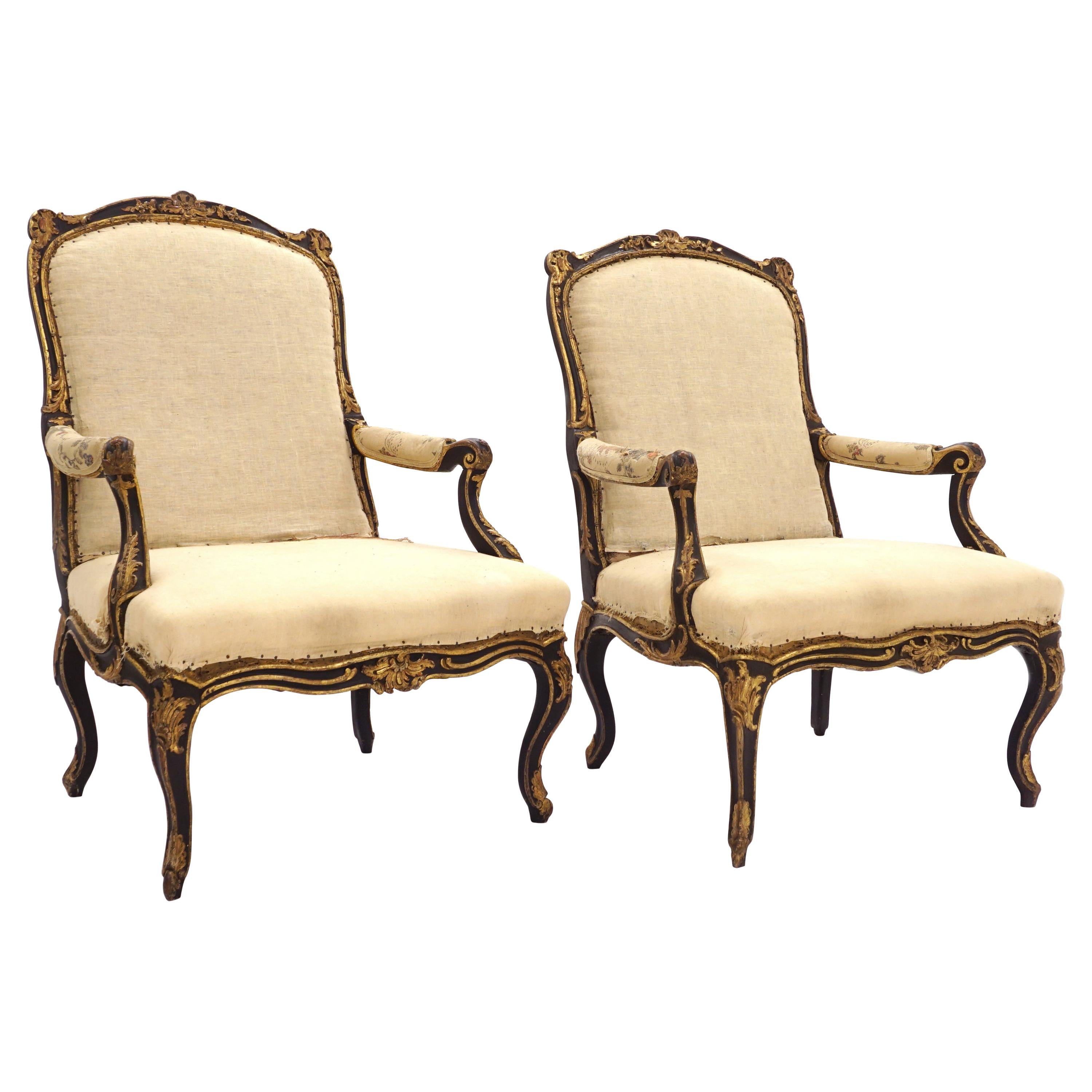Impressive Pair of French Mid 18th Century Black and Gilt Rococo Armchairs For Sale