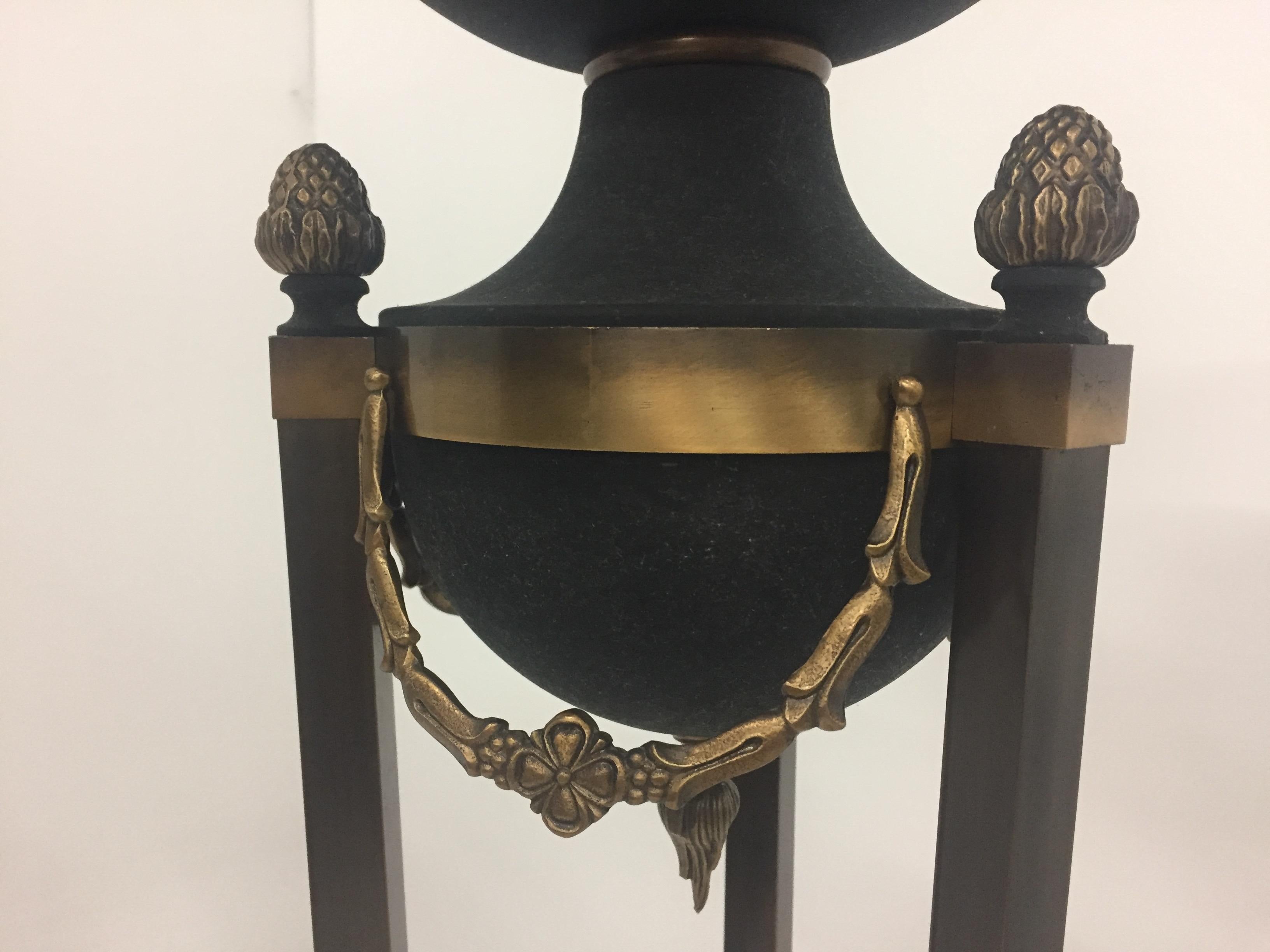 Beautiful elegant pair of patinated metal and brass Italian Hollywood Regency style torchieres having lovely neoclassical acorn finials and garland decoration and 3 paw feet at the bottom of each lamp.
Takes a candlebara shaped bulb and has