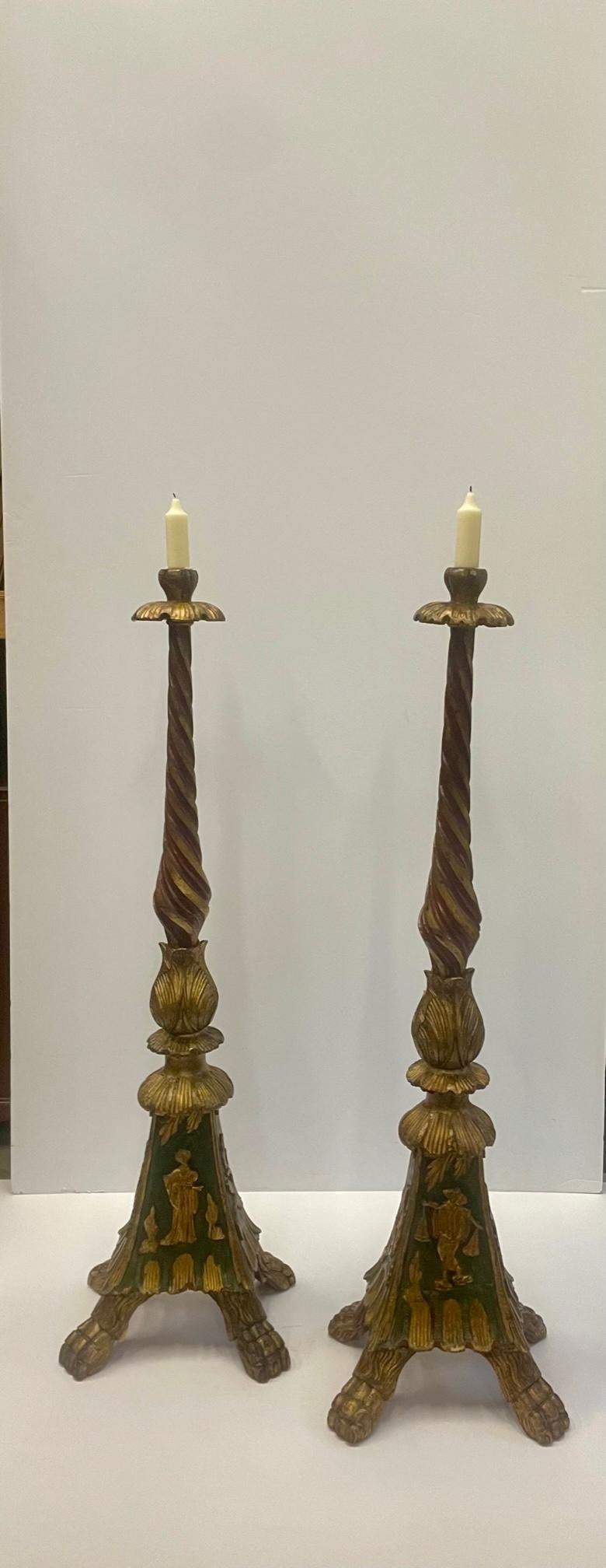 Impressive in scale, beautiful carved wood candlesticks with gilt painted decoration.