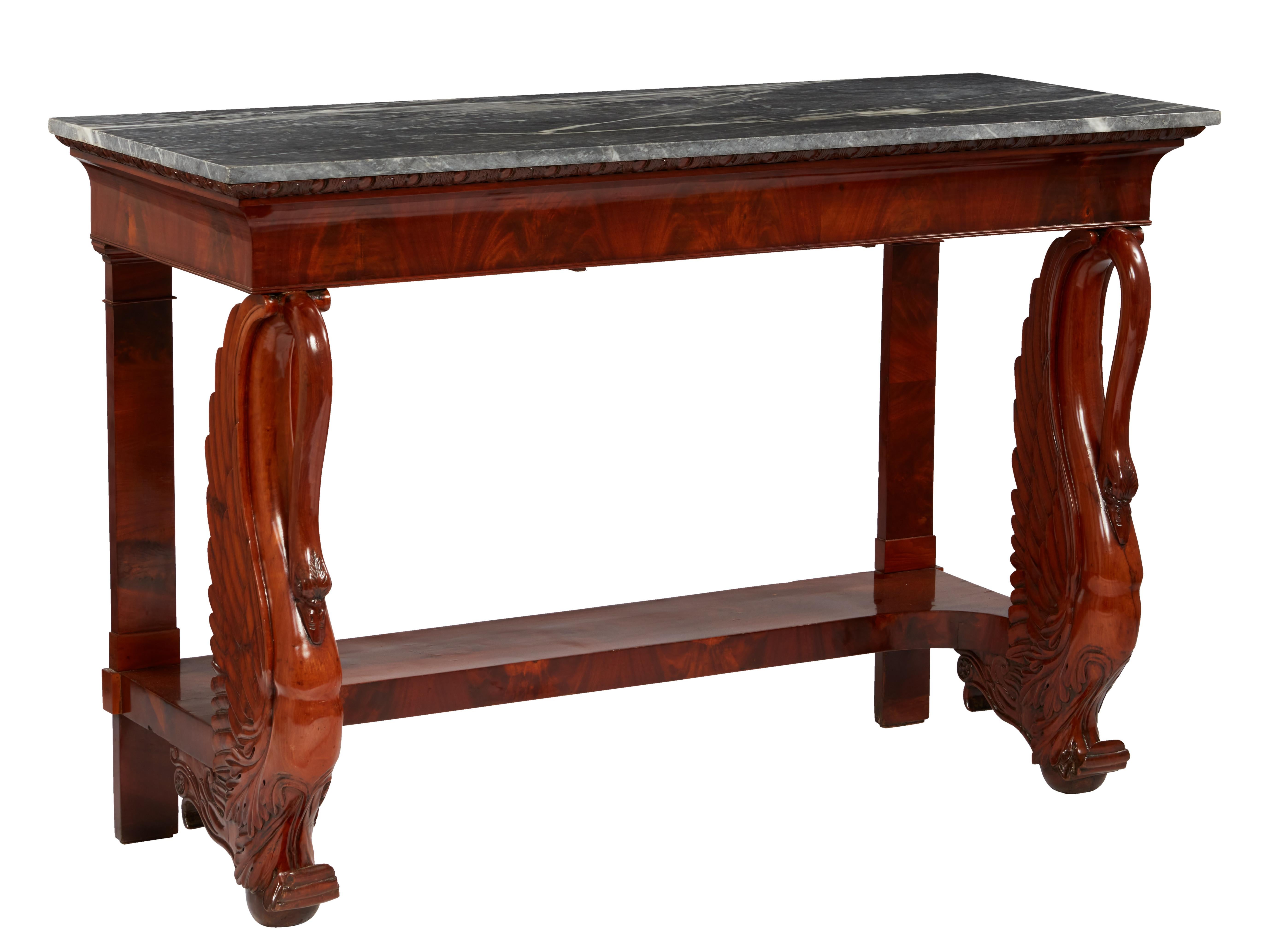 Marble tops set on a veneered flame mahogany frieze with finely carved acanthus leaf molding. Supported by a pair of superbly detailed solid mahogany swans flanking a veneered stretcher.