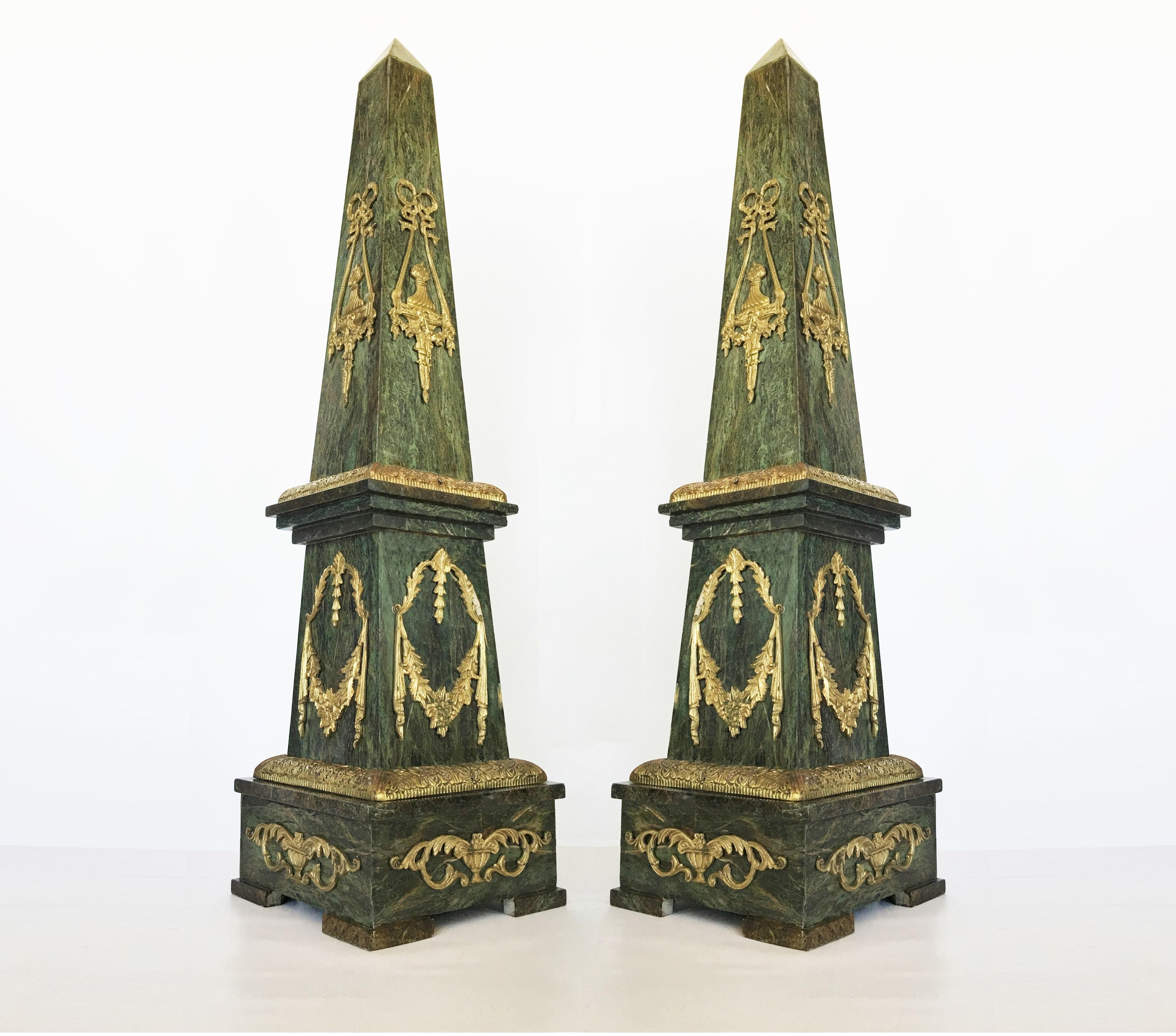 Pair of large marble obelisks. Made from solid Verde Antico marble with bronze neoclassical style decorative mounts on all four sides.