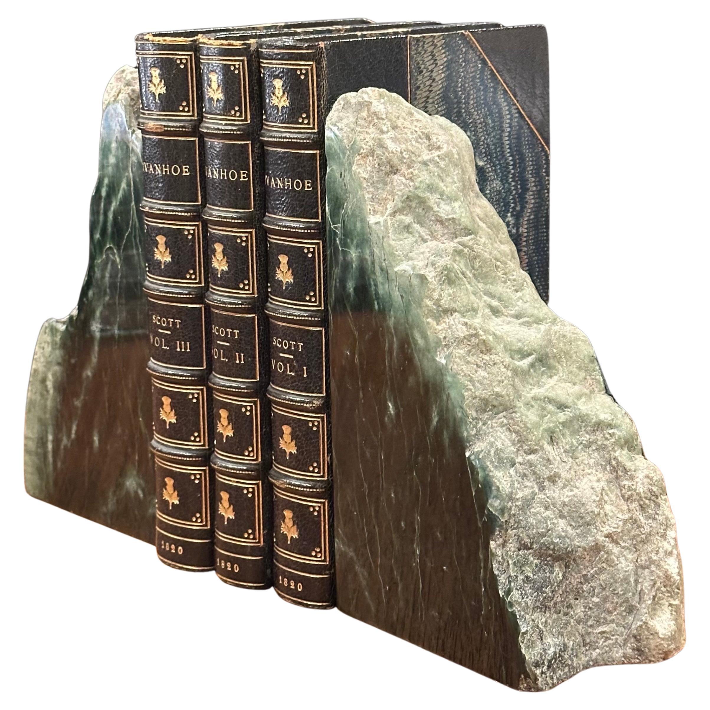 An impressive pair of raw green marble bookends, circa pre-history.  The bookends were formed by fossilization over millions of years and are finished with the exterior edges retaining raw, organic texture.  The set is in very good condition with no