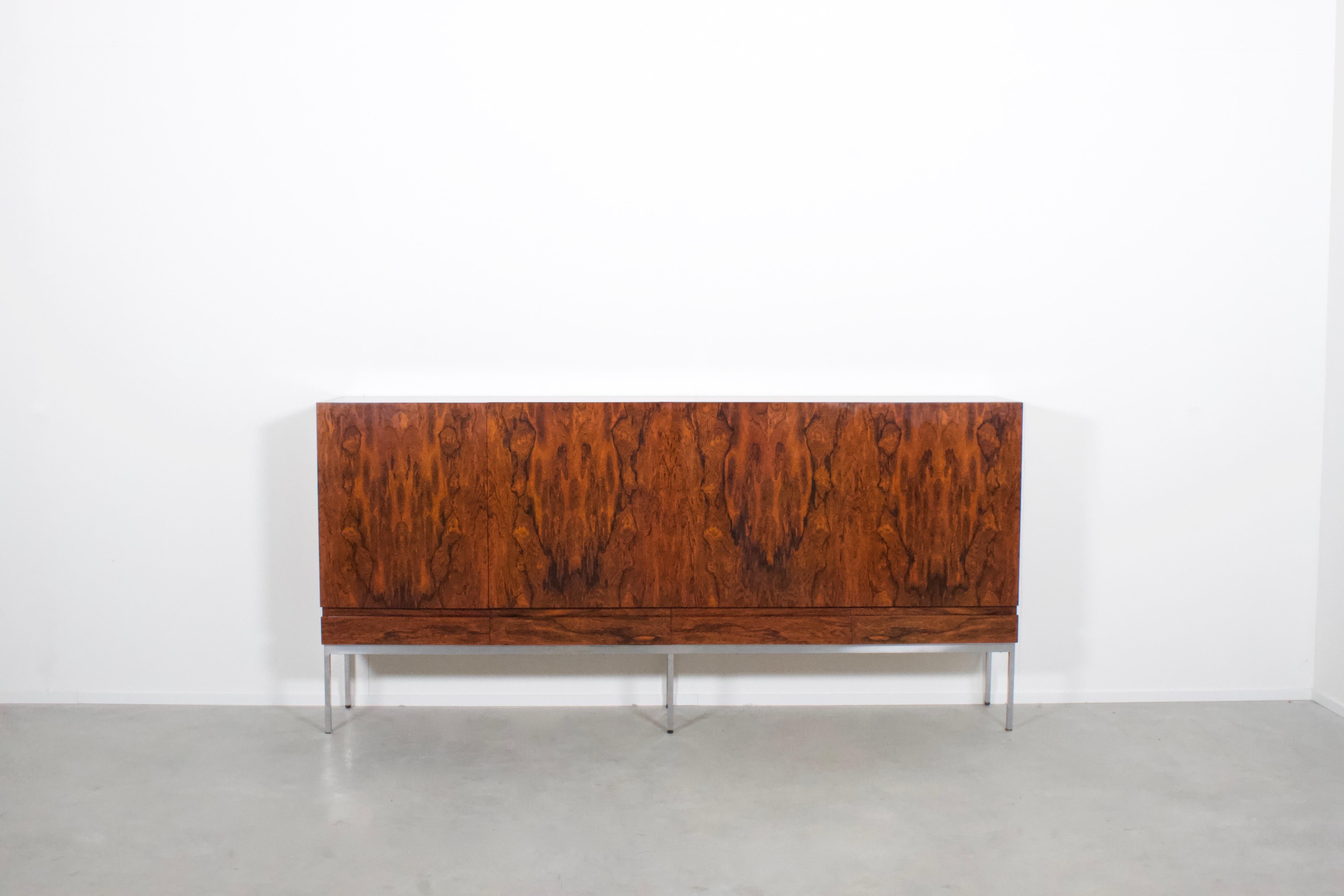 High quality Behr B60 sideboard / highboard in excellent condition.

Designed by Dieter Waeckerlin in the 1960s.

This rare version is made of a beautiful Rio Rosewood veneer which has a gorgeous grain and color.
It has an up to date EU CITES