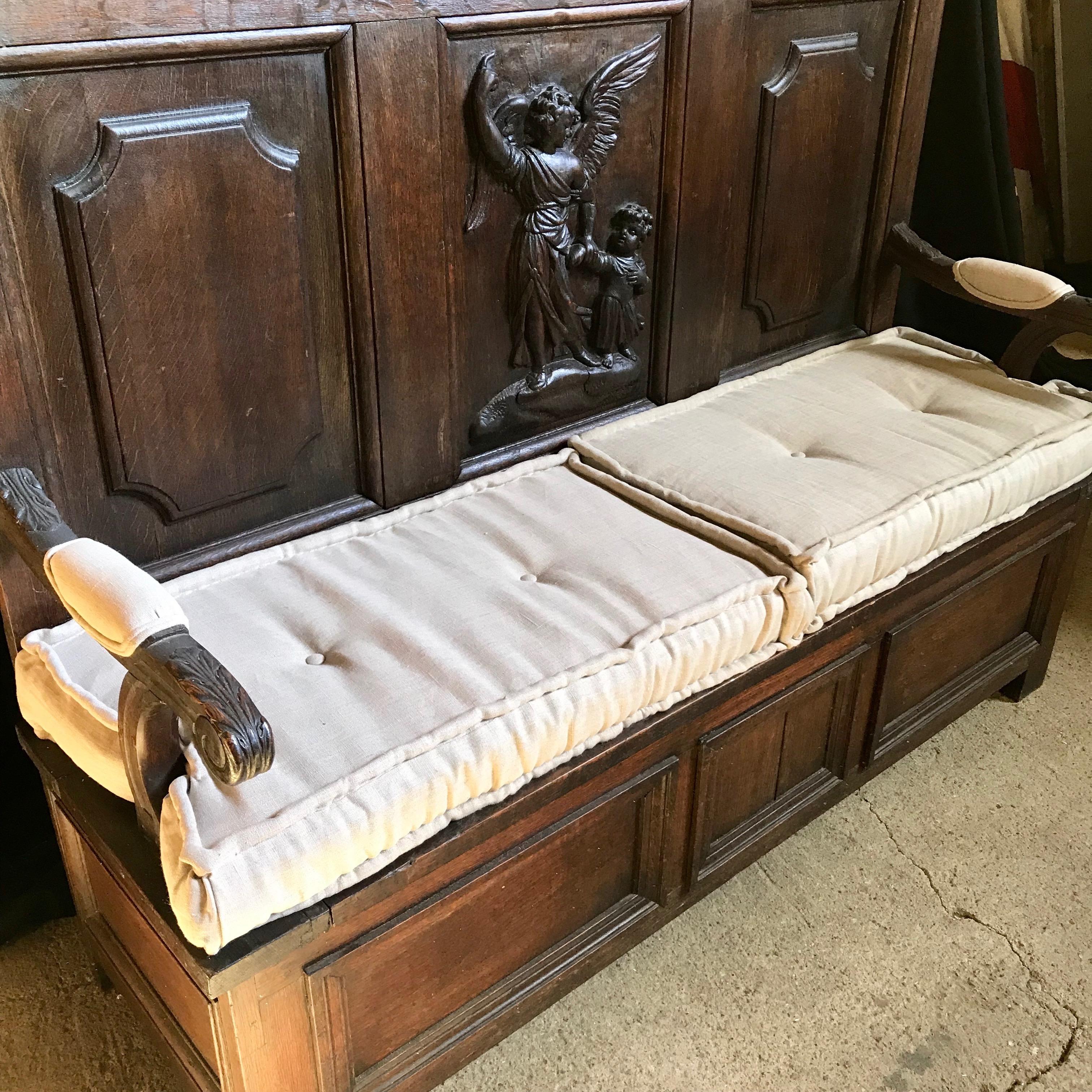 A very impressive high back French bench having gorgeous carved central angelic figure, carved wood curlicue arms with upholstered arm rests, and a seat that lifts to reveal storage inside. Comes with new white duck seat cushions. #4863

arm height