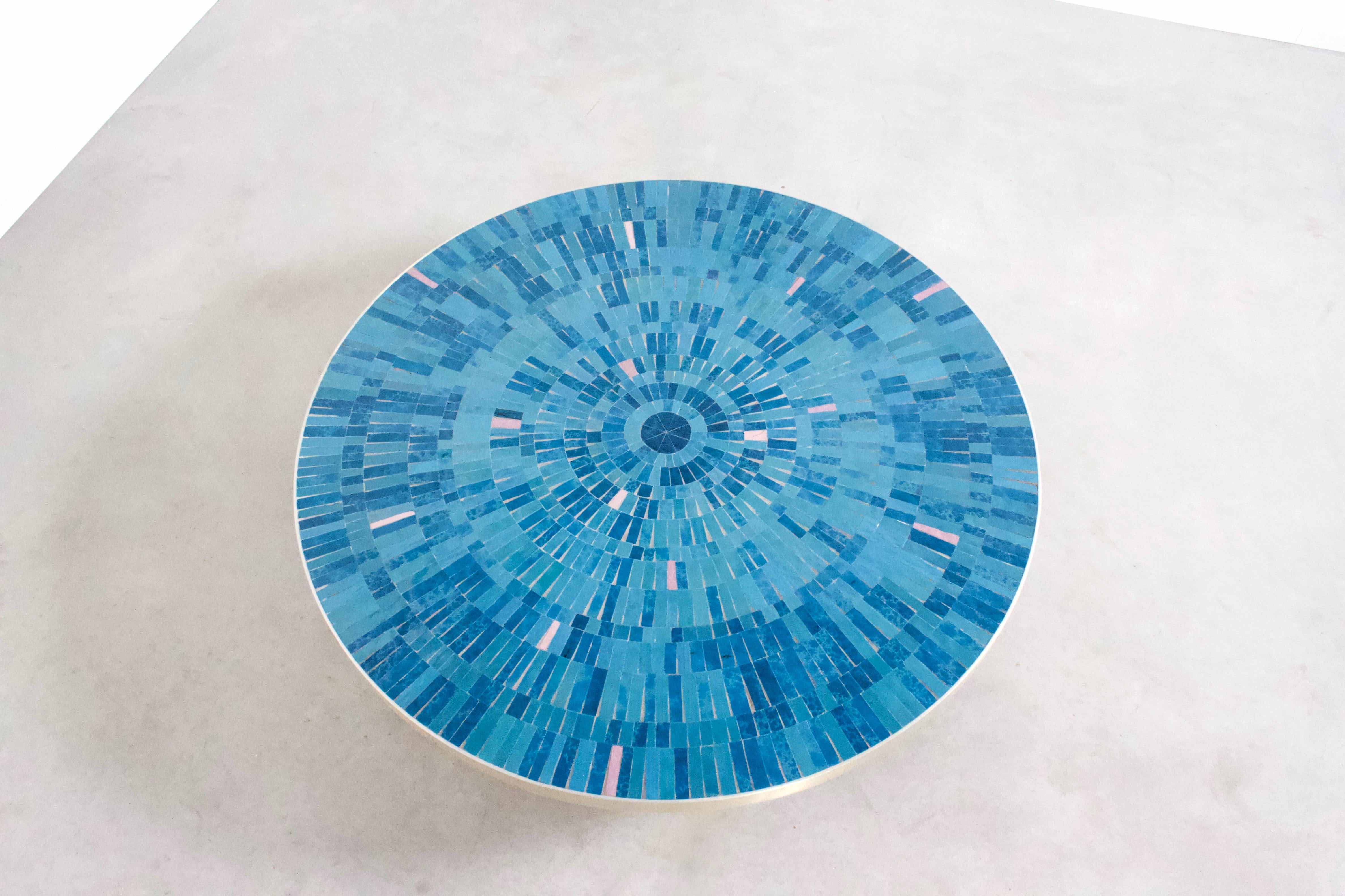 Impressive coffee table by Berthold Müller in excellent condition.

Manufactured by Mosaikwerkstatt Berthold Müller-Oerlinghaus

The round mosaic top of this table is composed of tiles in various colors of blue and pink.
The rim of the top is