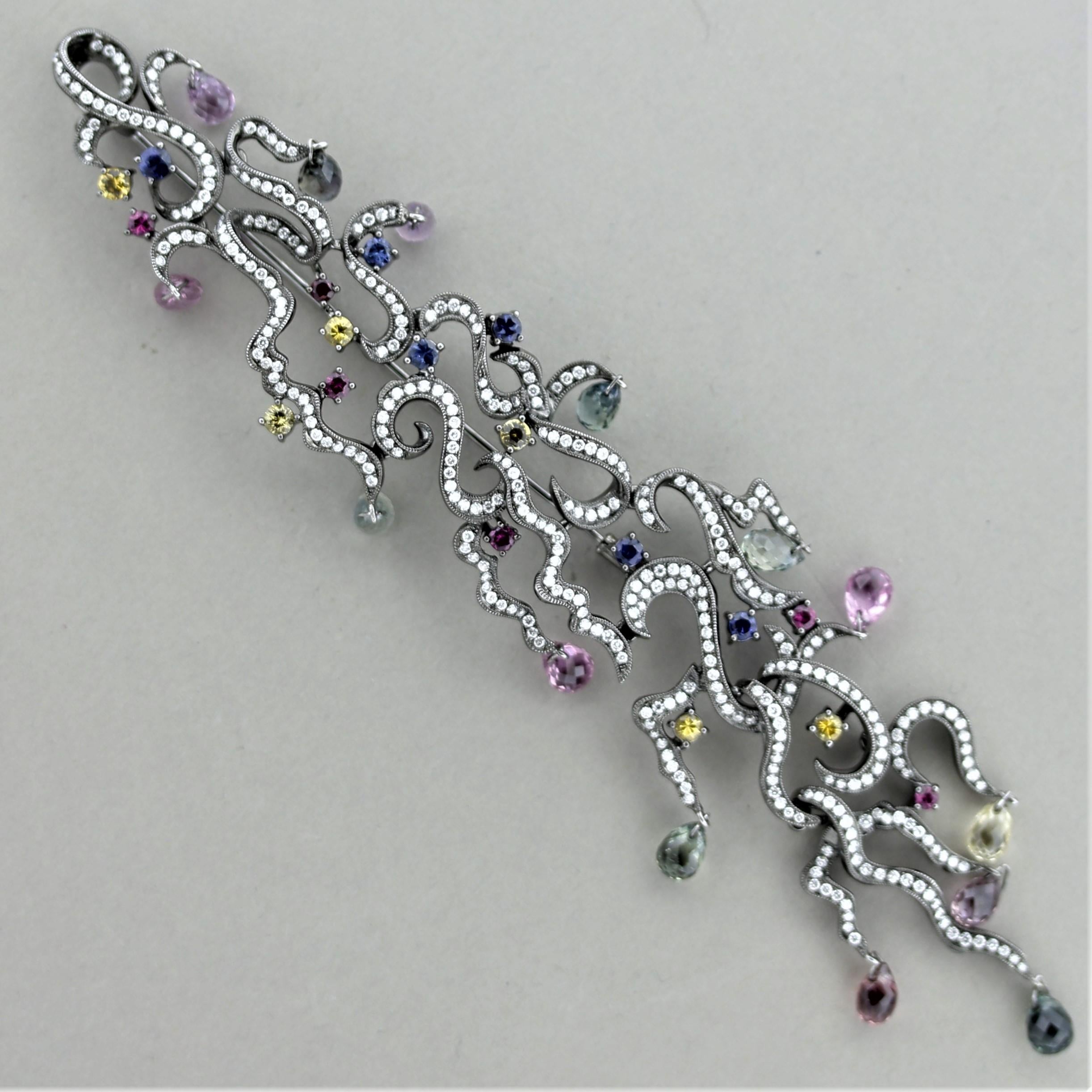 Simply stunning and exceptional, as much a piece of fine art as a piece of jewelry. The brooch features 16 carats of bright sapphires in just about every color and are cut as rounds and beautiful briolettes which drop and dangle like berries on the