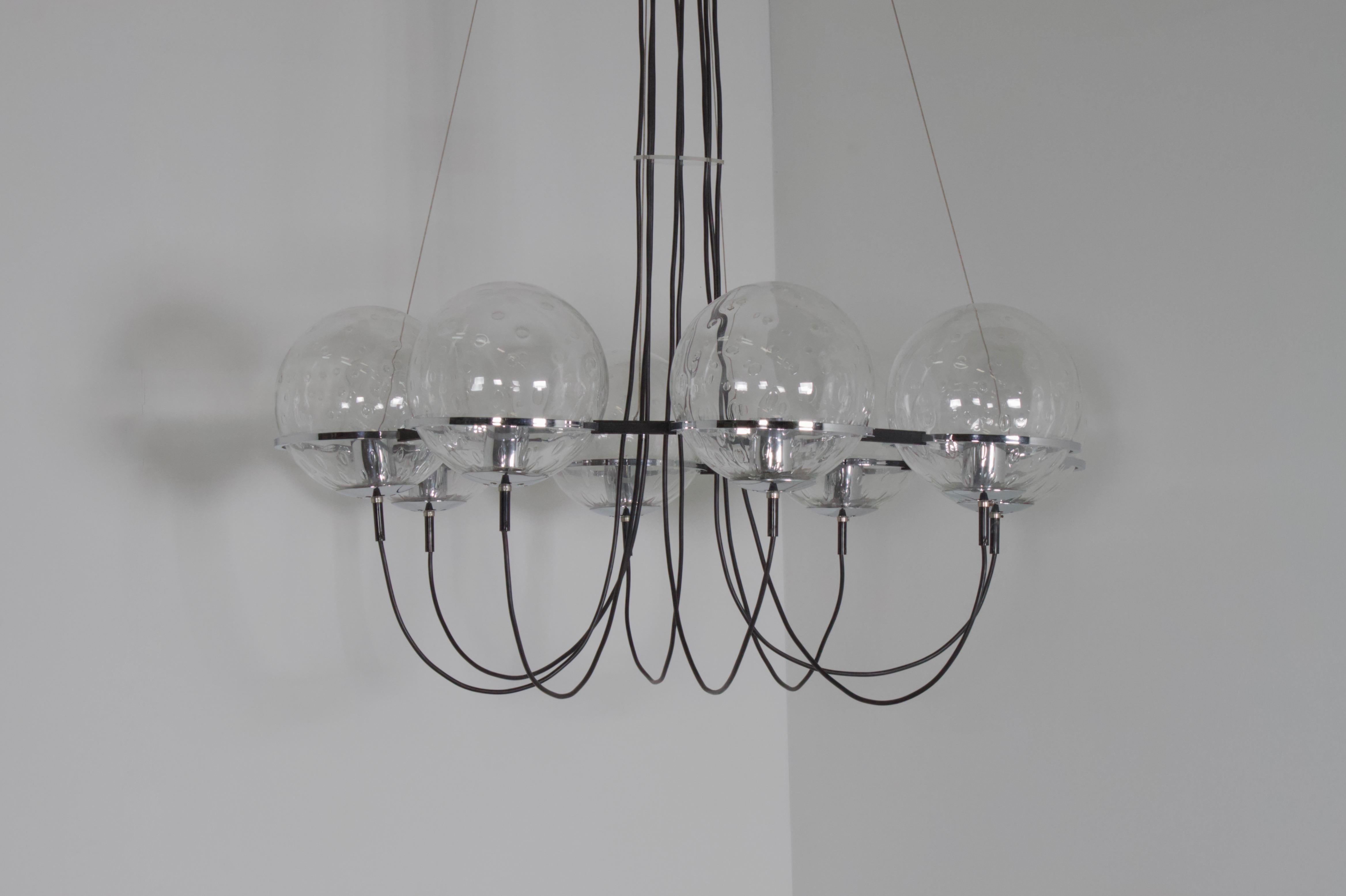 Impressive RAAK Amsterdam chandelier. 

Marked: RAAK Amsterdam. 

Globes: Eight hand blown “Light Drops” globes with a teardrop pattern trapped inside the glass.

Ring: Black metal with chrome, 116 cm. in diameter. 

Hardware: Chrome. 

Wiring: