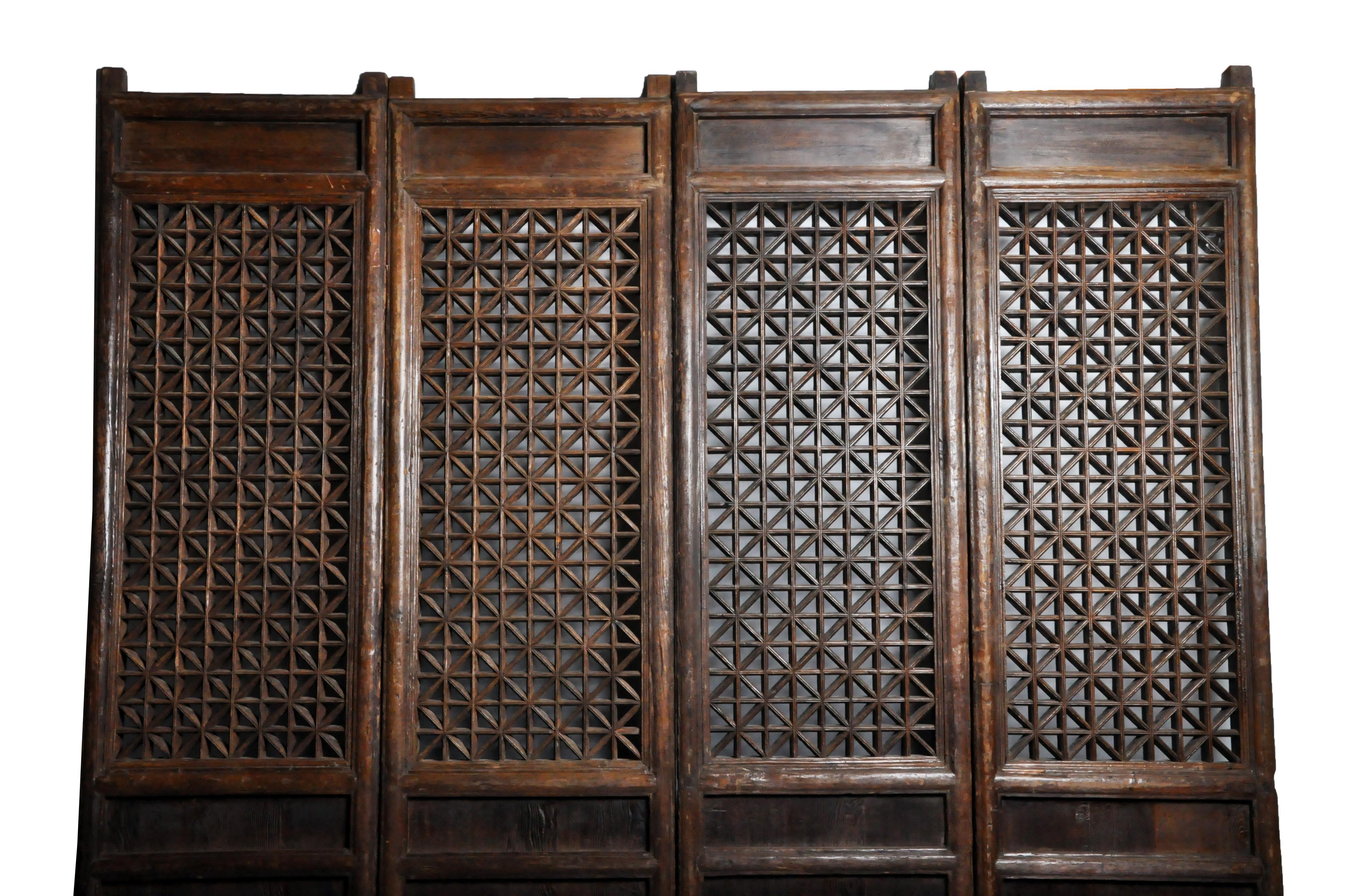 This unusually large set of courtyard doors is in original condition, with no repairs of any kind or any modifications to their original patina. They are made from elmwood, came from Shanxi Province and date to the early 1800s. The doors slid into