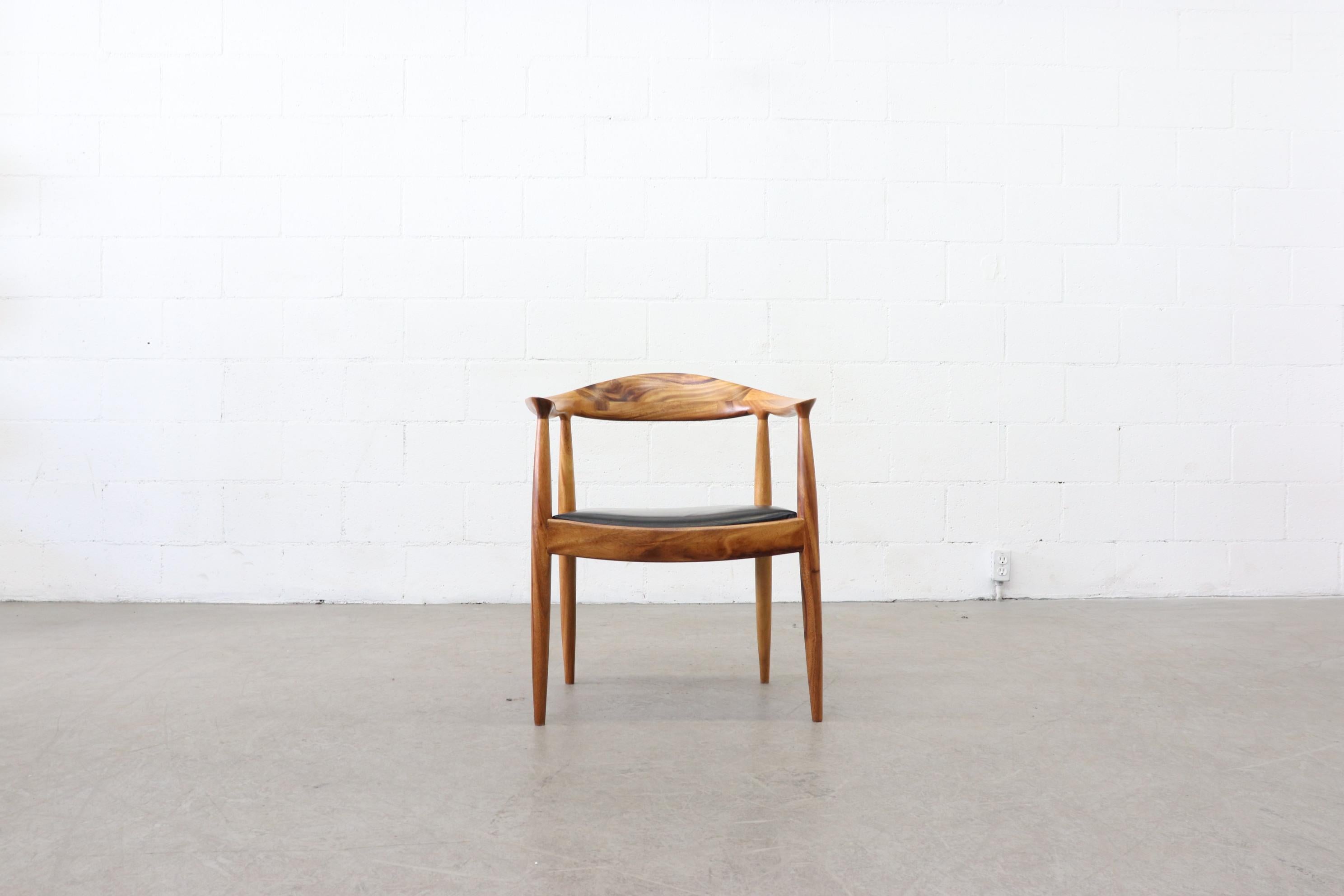 Impressive set of 6 lightly refinished Hans Wegner inspired chairs. Carved wood with handsome natural grain pattern. Original black leather seats with visible wear, set is in original condition. Based on the JH-503, named “The most beautiful chair