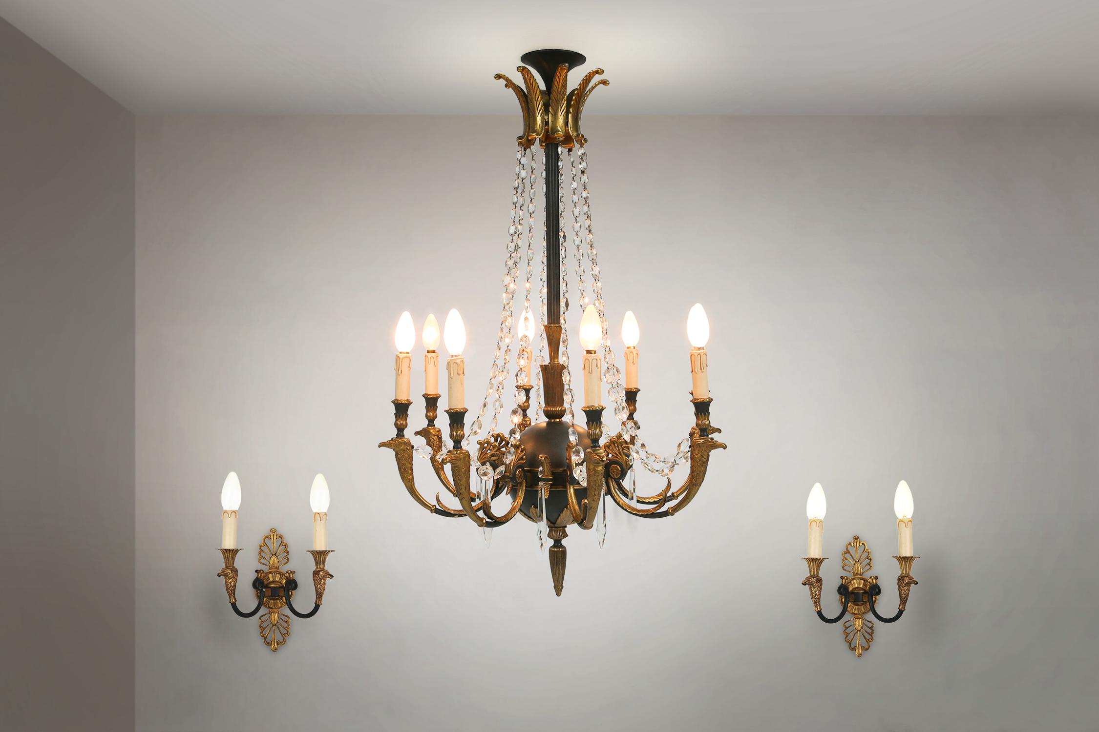 Belgium / 1950 / chandelier or pendant lamp with 2 wall lamps / bronze and glass / empire

A beautiful set containing a large Chandelier with 8 light arms and 2 wall lights with each 2 arms. Made in bronze in Belgium in the 1950s in Empire style.