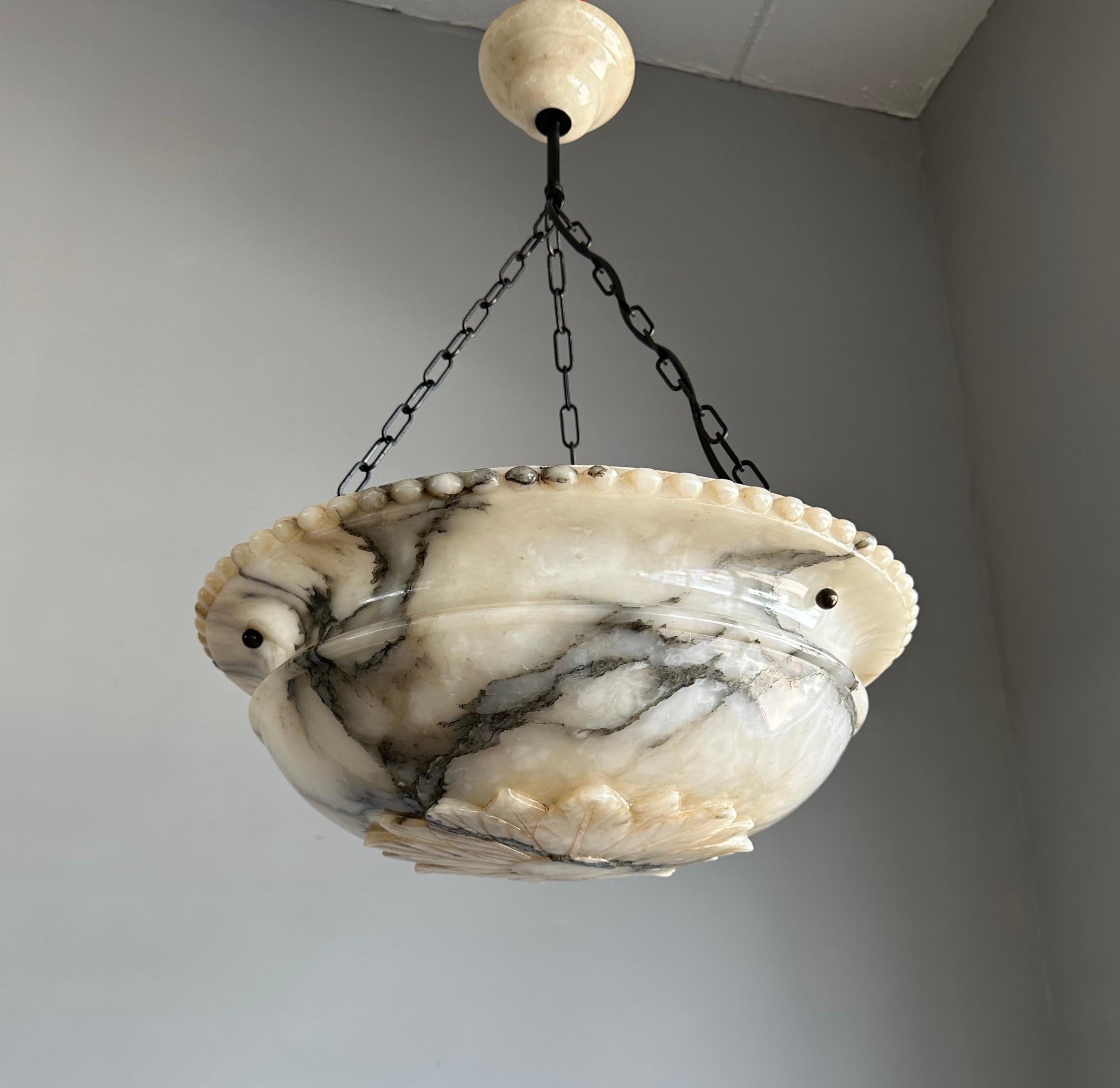 Antique 3-light chandelier with a good size and beautifully carved alabaster shade.

Thanks to its size, its deep bowl shade, its classical design and beautifully spread black veins this great alabaster chandelier is bound to light up someone's days
