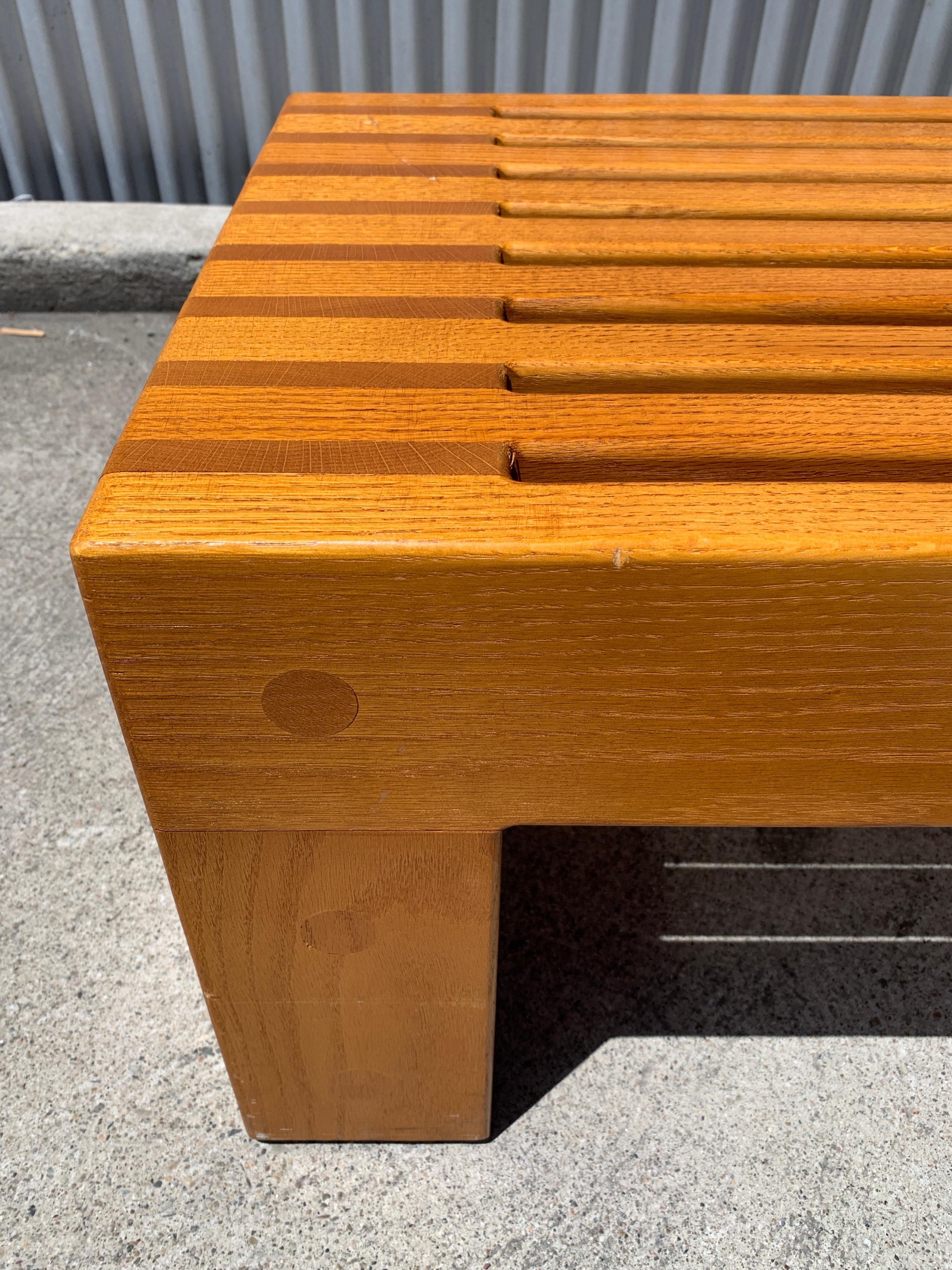 Custom Ricardo Legorretta white oak slat bench. Legorretta is well known for dozens of high profile private and municipal buildings and public spaces throughout the world. His distinctive shapes and bold colorful contrasts make powerful references