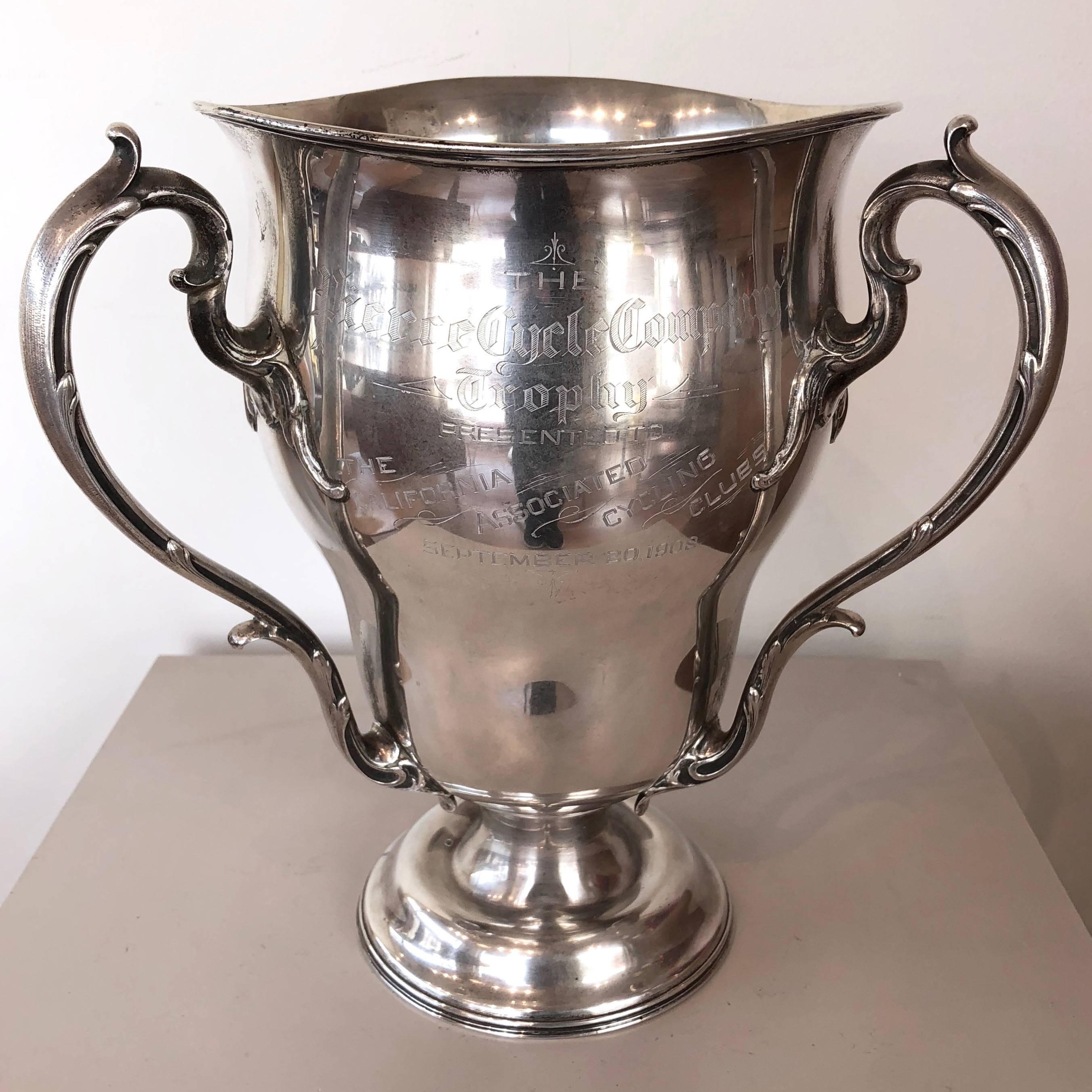 An impressively sized and historically important Pierce Cycle Company 1908–1913 perpetual cycling trophy crafted in sterling silver by R. Wallace & Sons.

Three-handled loving cup awarded on a yearly basis to cycling clubs hailing from San