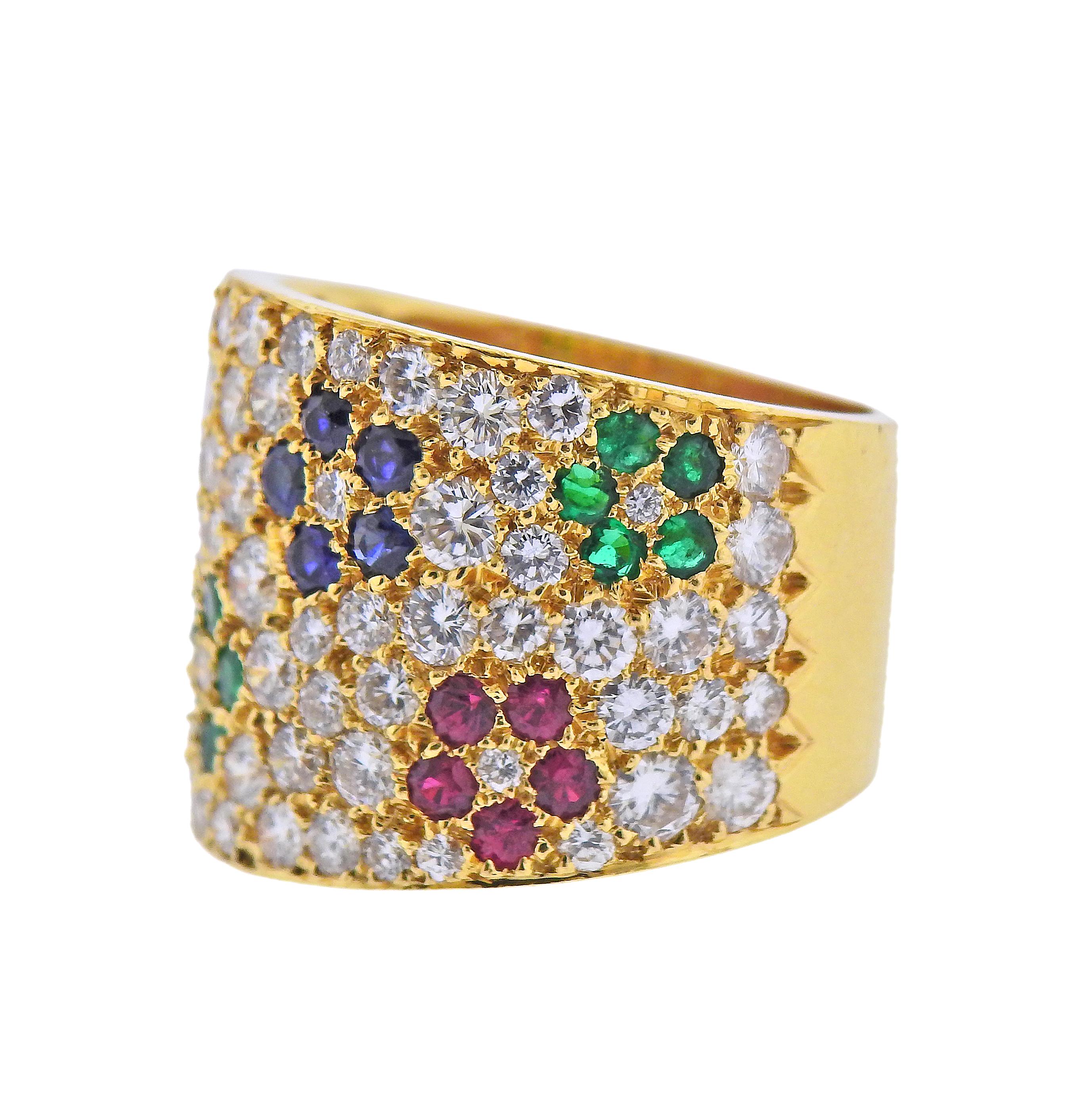 Impressive 18k yellow gold wide band ring by Van Cleef & Arpels, adorned with rubies, sapphires, emeralds flowers, and approx. 4.00ctw in diamonds. Ring size - 7.25, ring top is 18mm wide. Marked: Van Cleef Arpels, N 52742. Weight - 16.2 grams. 