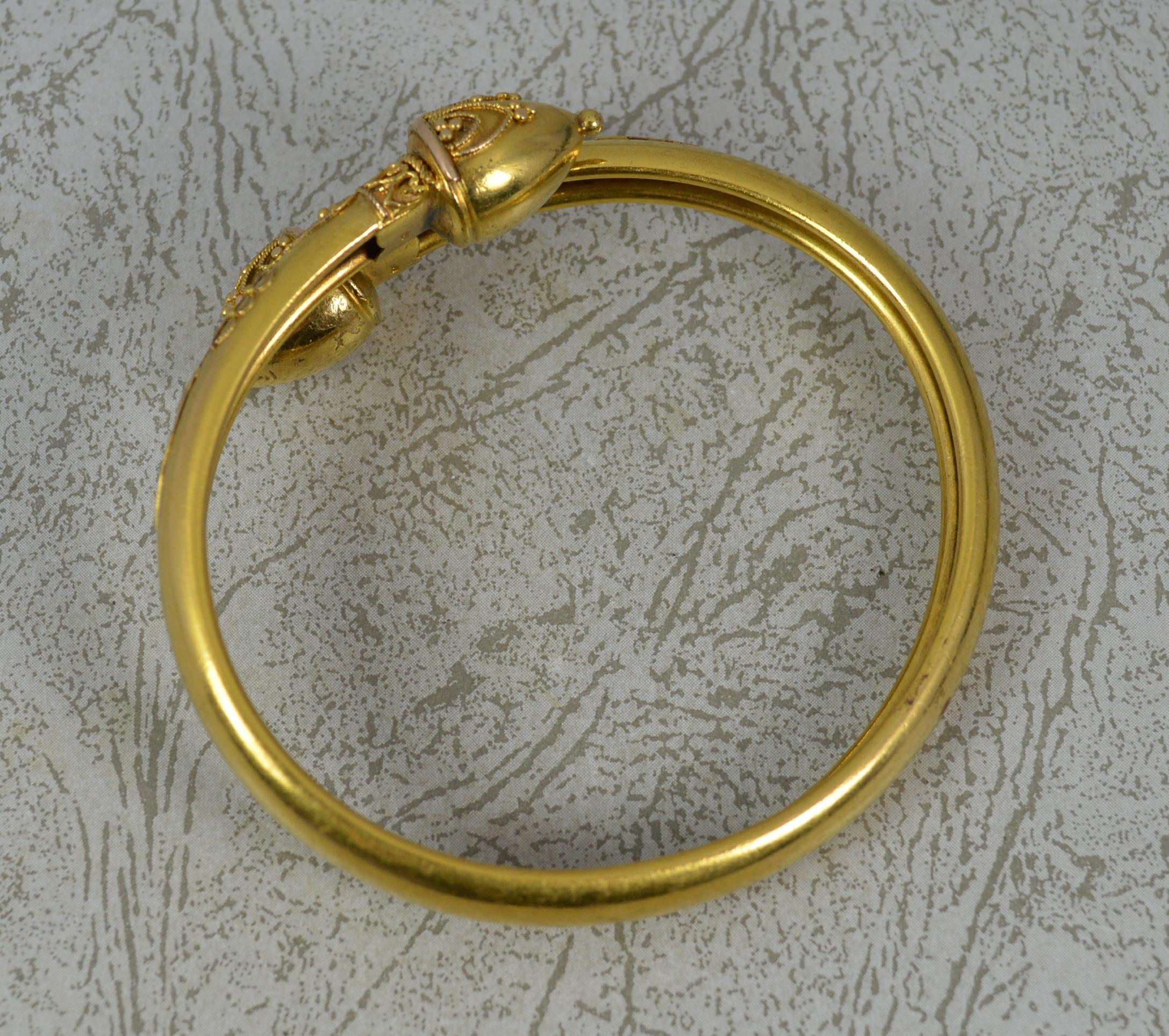 A superb Victorian period bangle. c1860-80
Modelled in a solid 15 carat yellow gold bangle throughout.
Crossover shape with a filigree design to the front and a plain, smooth band.

CONDITION ; Excellent. Crisp design. Issue free. Light wear only.
