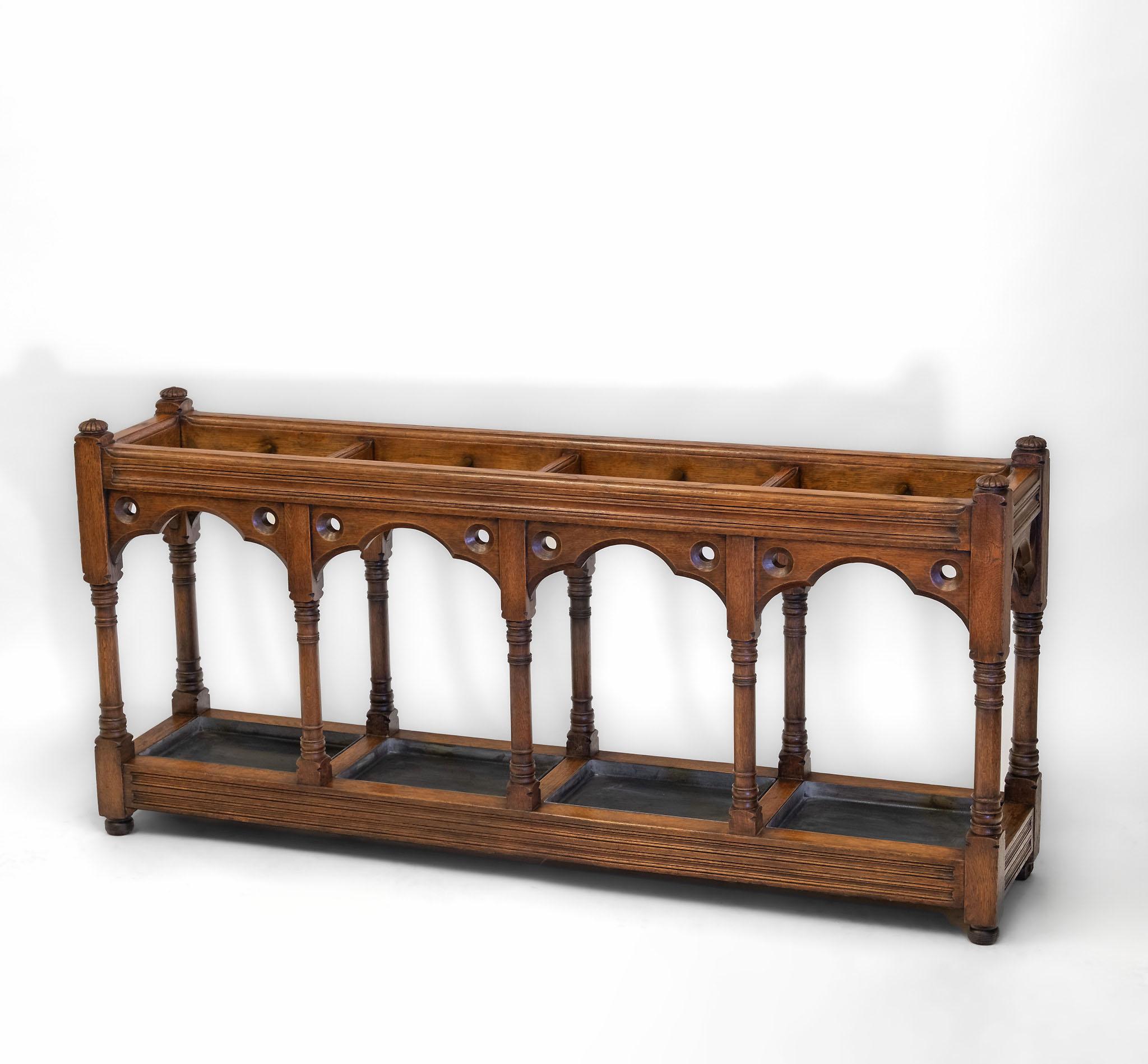 An impressive Victorian Gothic Revival country house oak umbrella / stick stand. English. Circa 1880.

Delivery included in mainland England or Wales.

Made in solid oak, the stand with an architectural influence, having trefoil arched friezes in