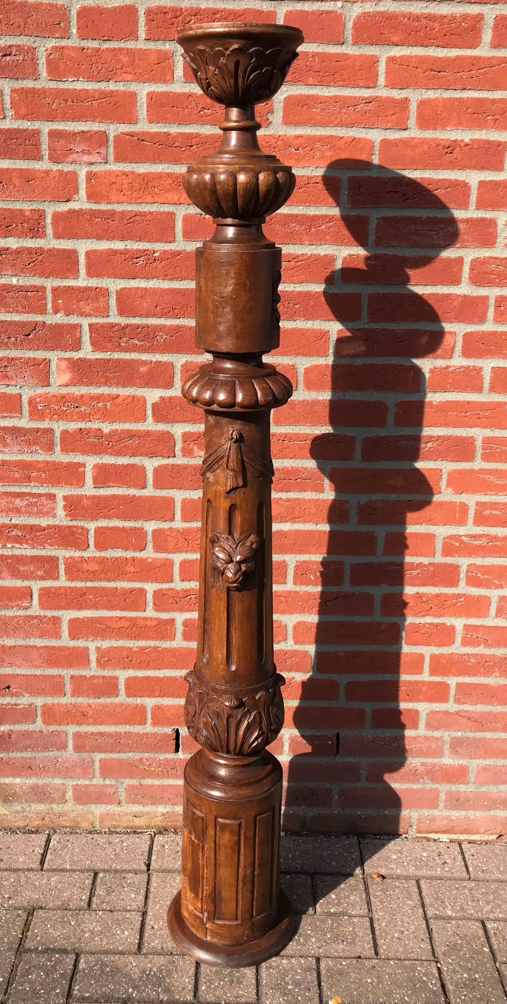 Great, sculptural stair newel post from the 1800s. 

This unique newel post and pedestal is beautifully and richly carved all around. Most impressive on this newel post are the realistic and fierce looking lion heads that are literally carved out of