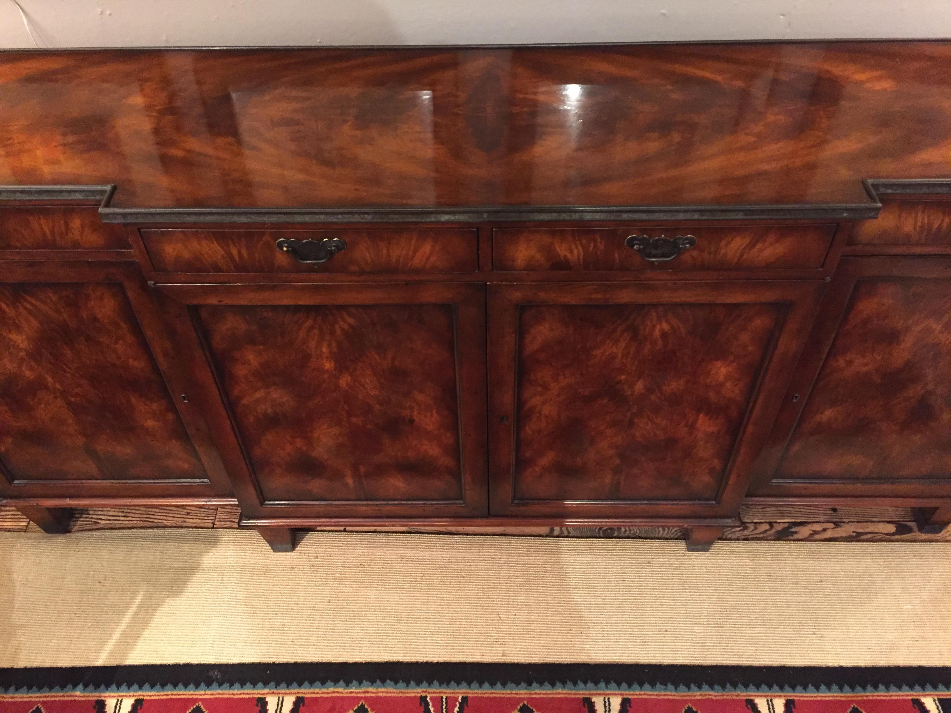Gorgeous and very large designer sideboard having wonderful grain, bronze gallery around the top, and lots of storage inside with 4 drawers and 4 paneled doors.

Depth center part 18
Depth side sections 16.