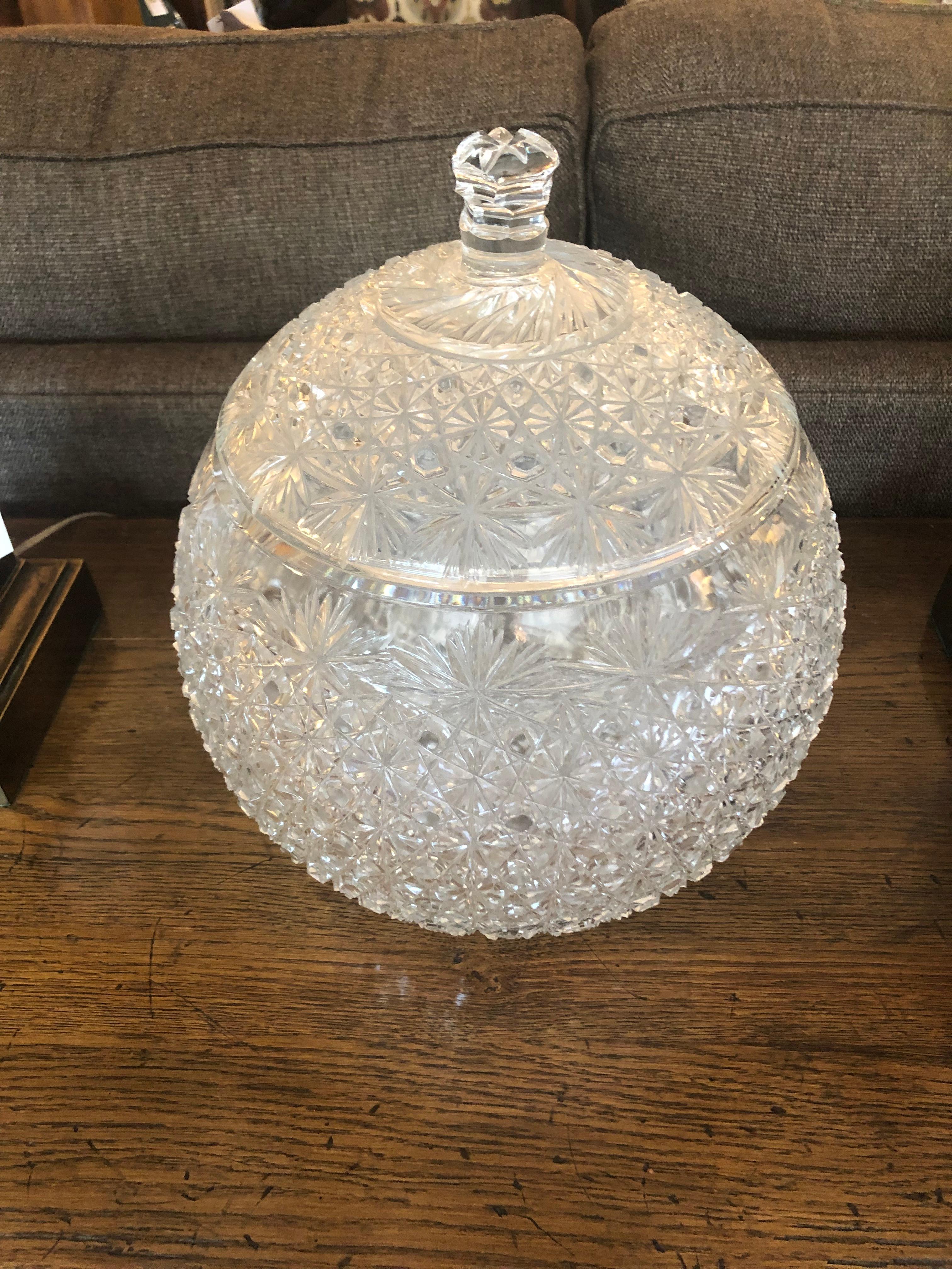 Eye catching glistening cut glass vessel with matching lid, very large and ornate.