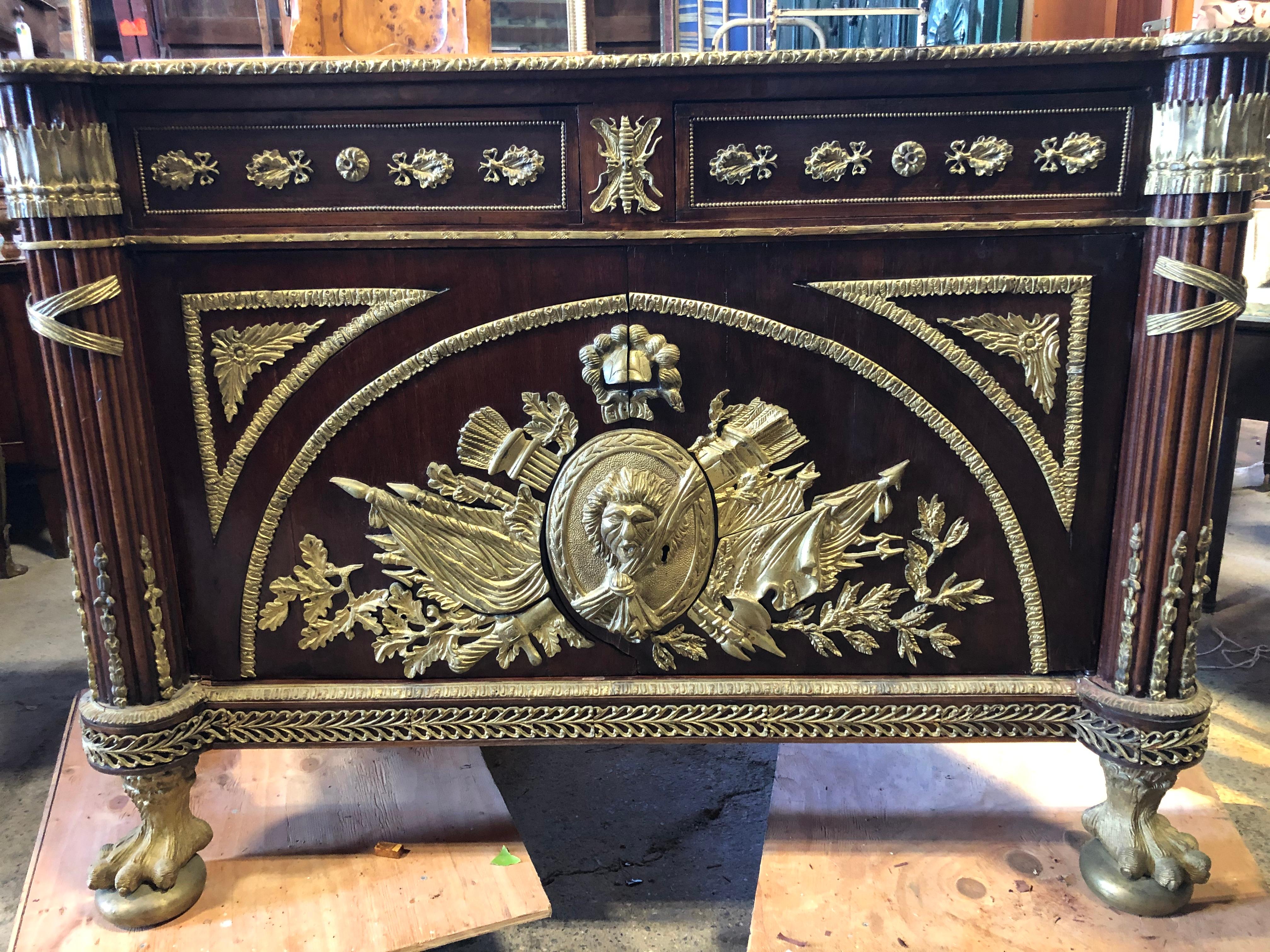 French revolution Louis XVI style sideboard, commode or buffet having gorgeous ornate bronze decoration over inlaid Marquetry body and elegant marble top. The ball and claw feet are super impressive. There are two drawers and large interior cabinet