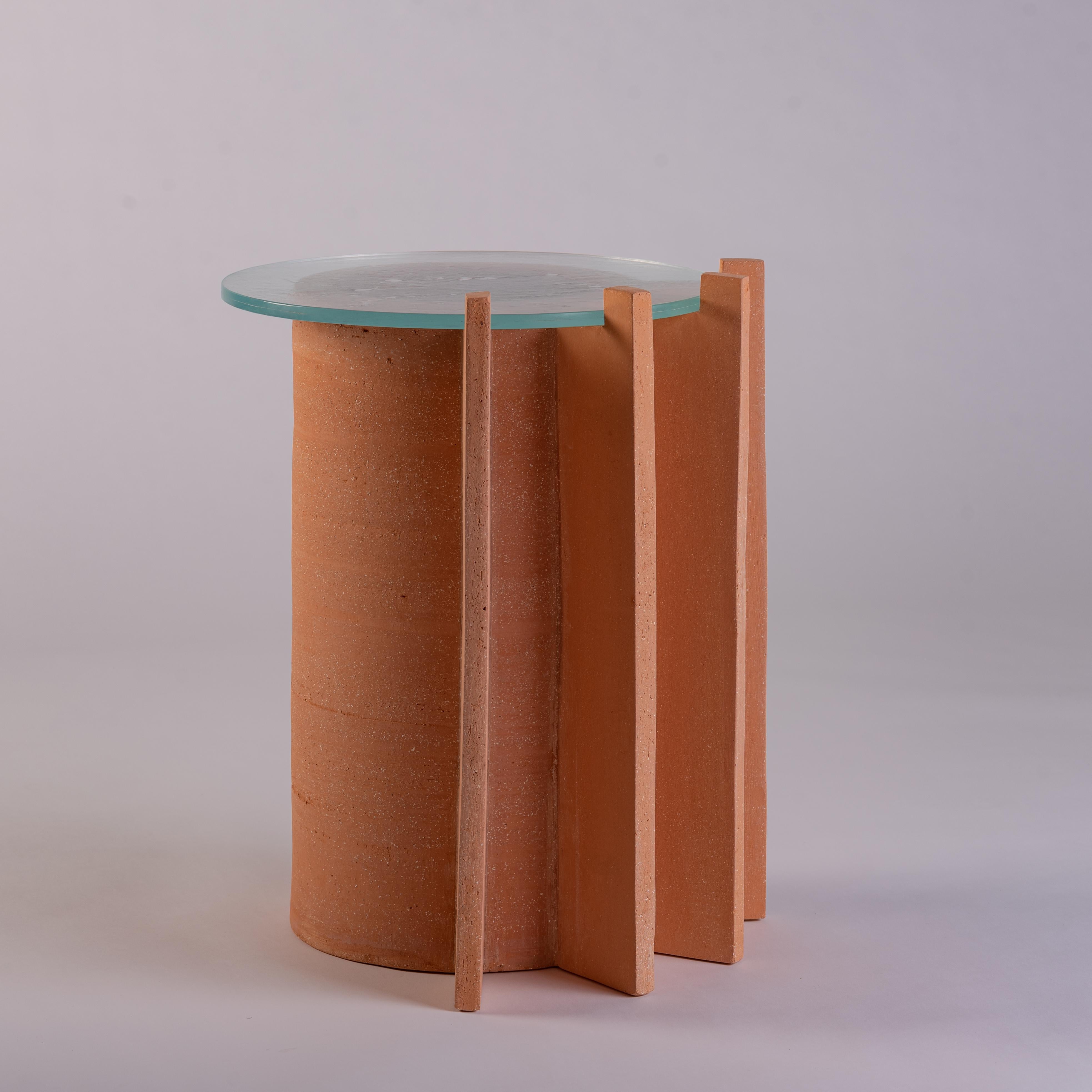 These unique side tables can only be described as a fusion of art, functional design and tradition connecting a space to day-to-day life. Each cylindrical table rises to reach a different height; one bears two decorative fins while the other table
