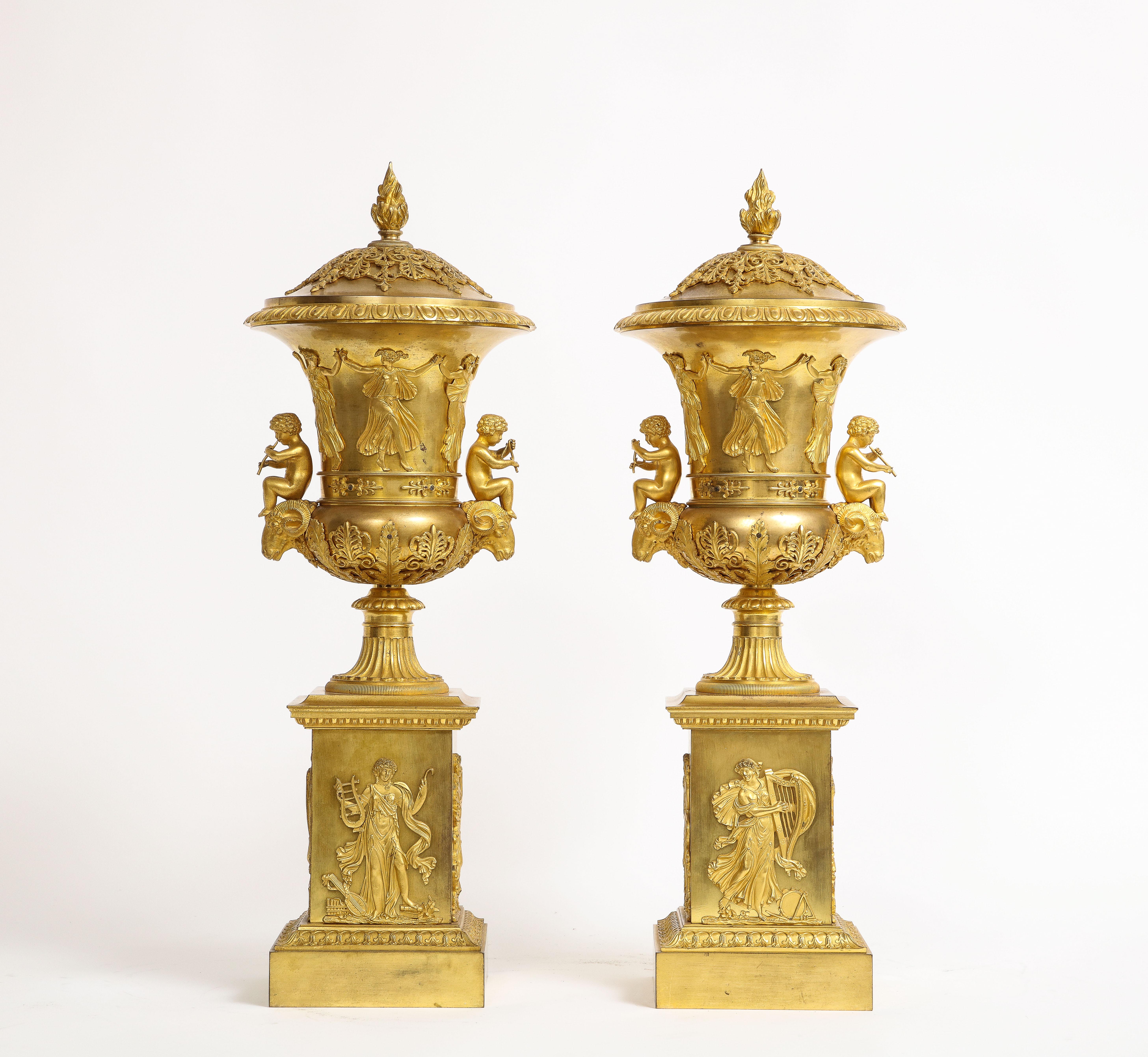 Une incroyable et rare paire de pots-pourris couverts en bronze doré du 19ème siècle, attribués à Thomier A Paris. Cette paire date de 1810, c'est-à-dire de l'illustre période de l'Empire français. Ces urnes remarquables sont de parfaits exemples de