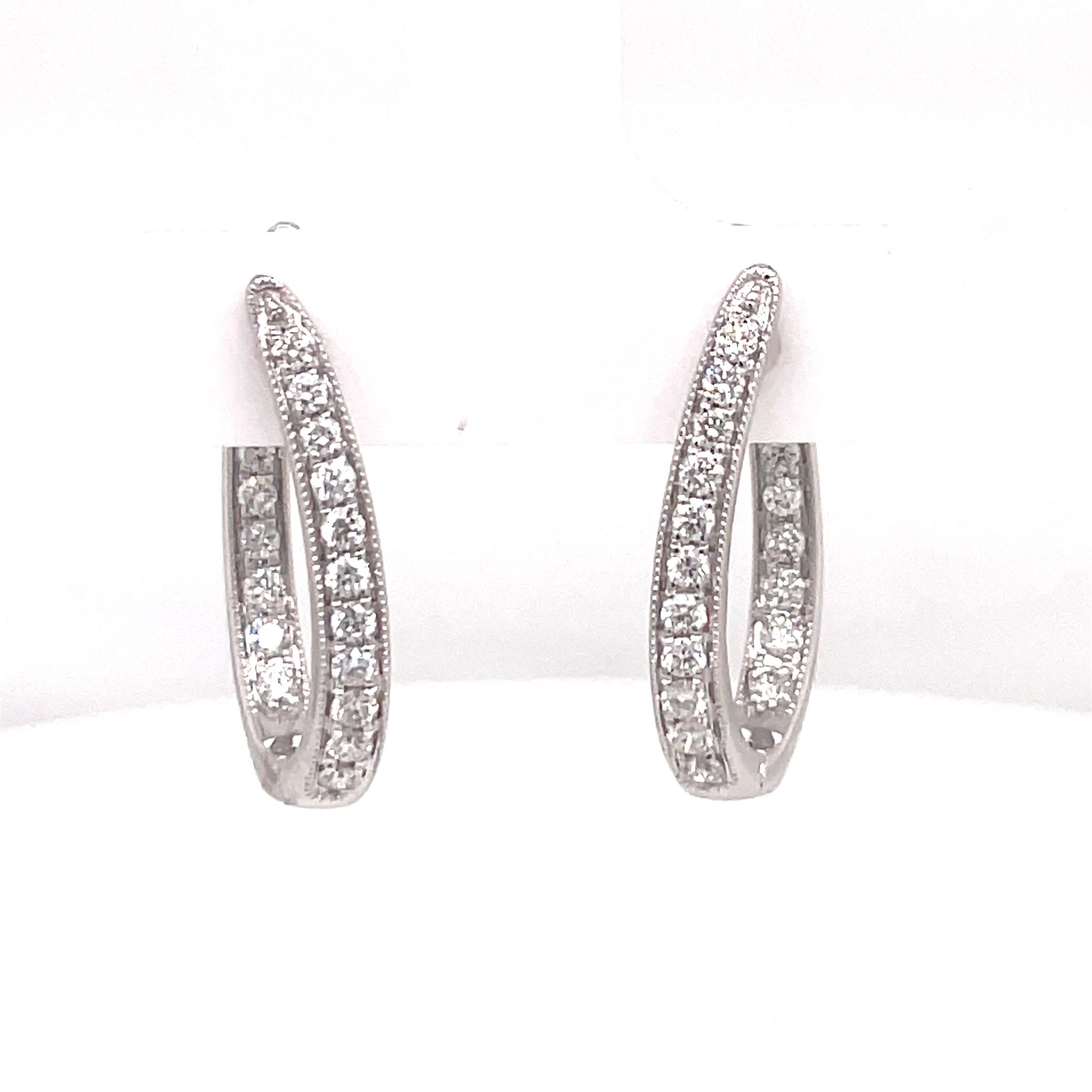 14 Karat White Gold hoop earrings featuring 38 round brilliants weighing 0.65 carats in a milgrain design. 
Color G-H
Clarity SI
Available in Yellow Gold
