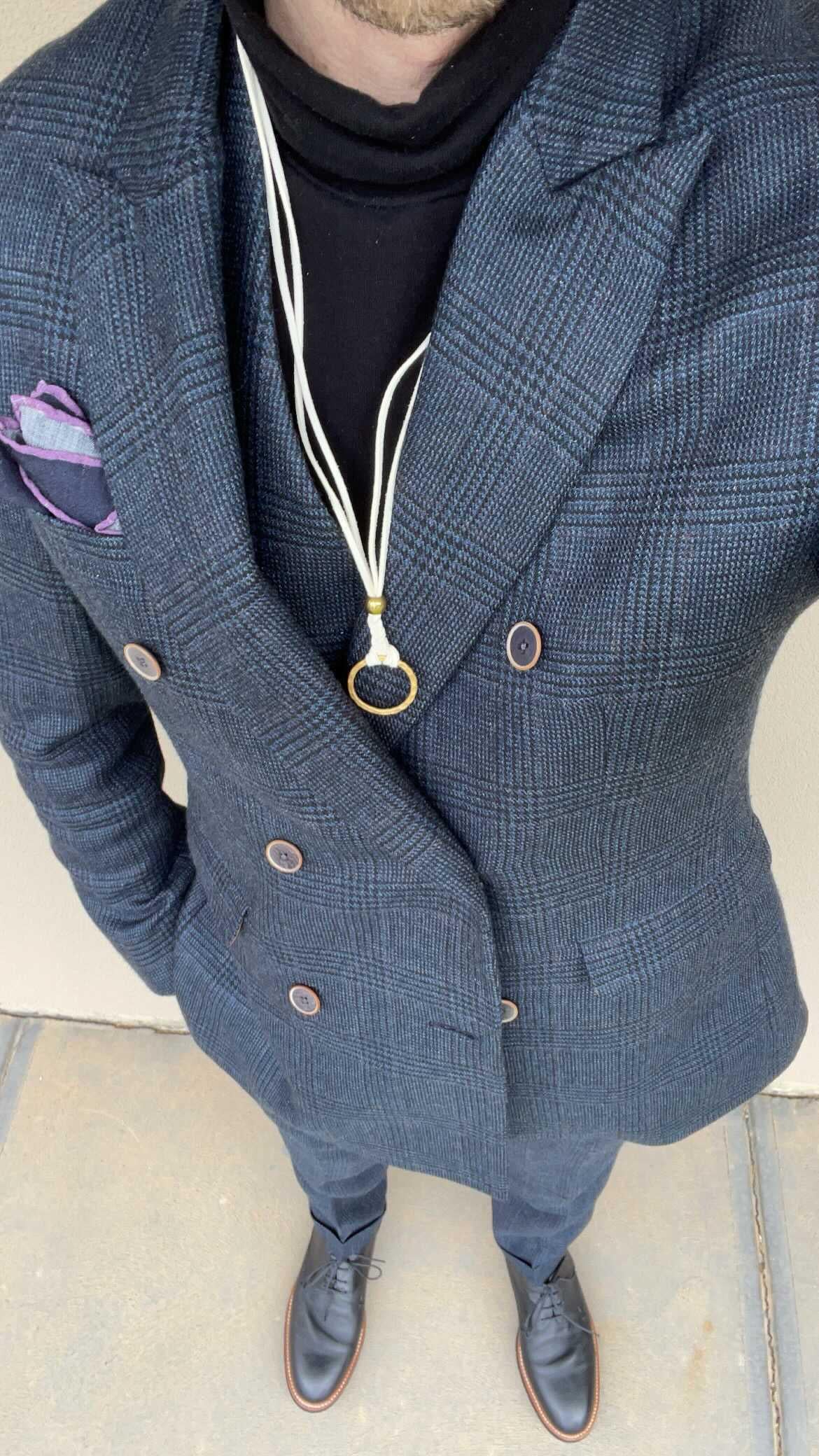 Story Behind The Jewelry
There is just something very masculine about a cord around and gentleman's neck, it enhances the outfit's overall elegance. The pendant is a hammered 14K gold circle. Circles are a universal symbol for wholeness and