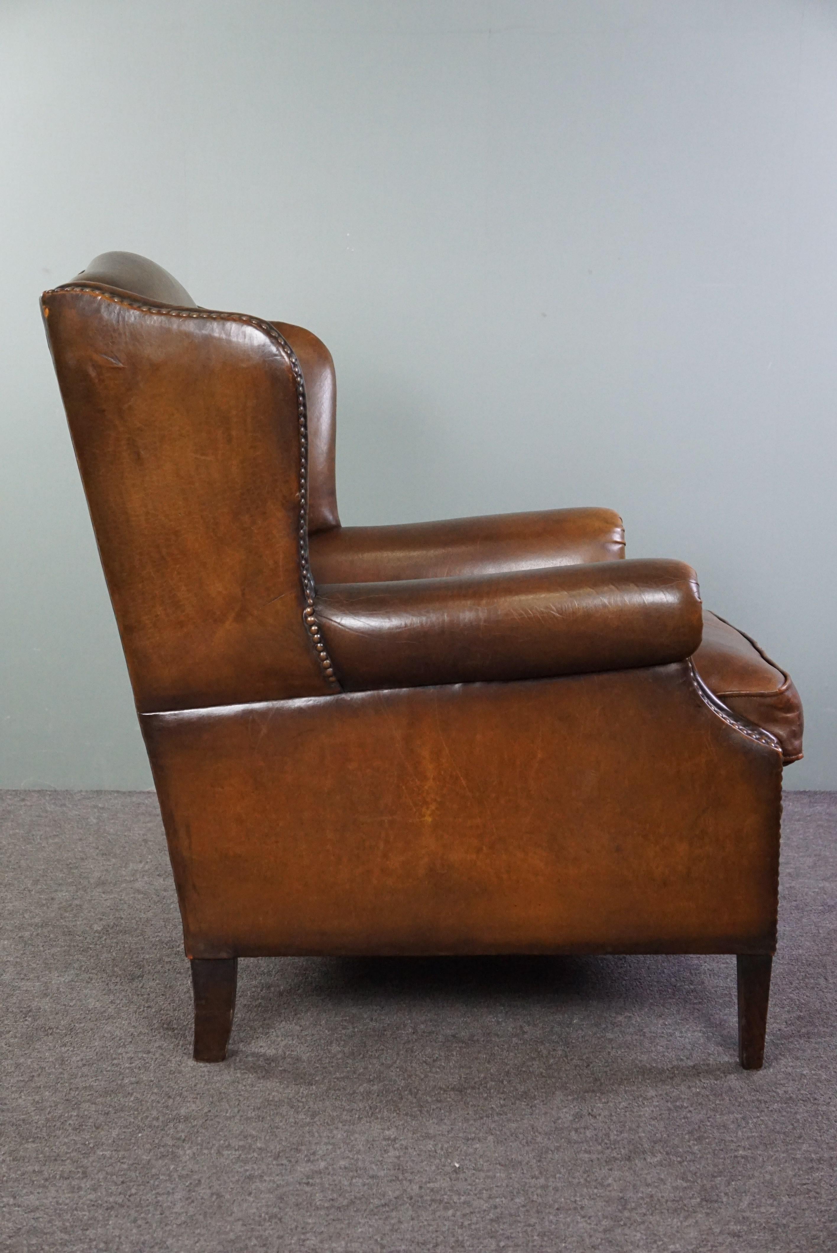 In good condition wingback chair made of sheepskin In Good Condition For Sale In Harderwijk, NL