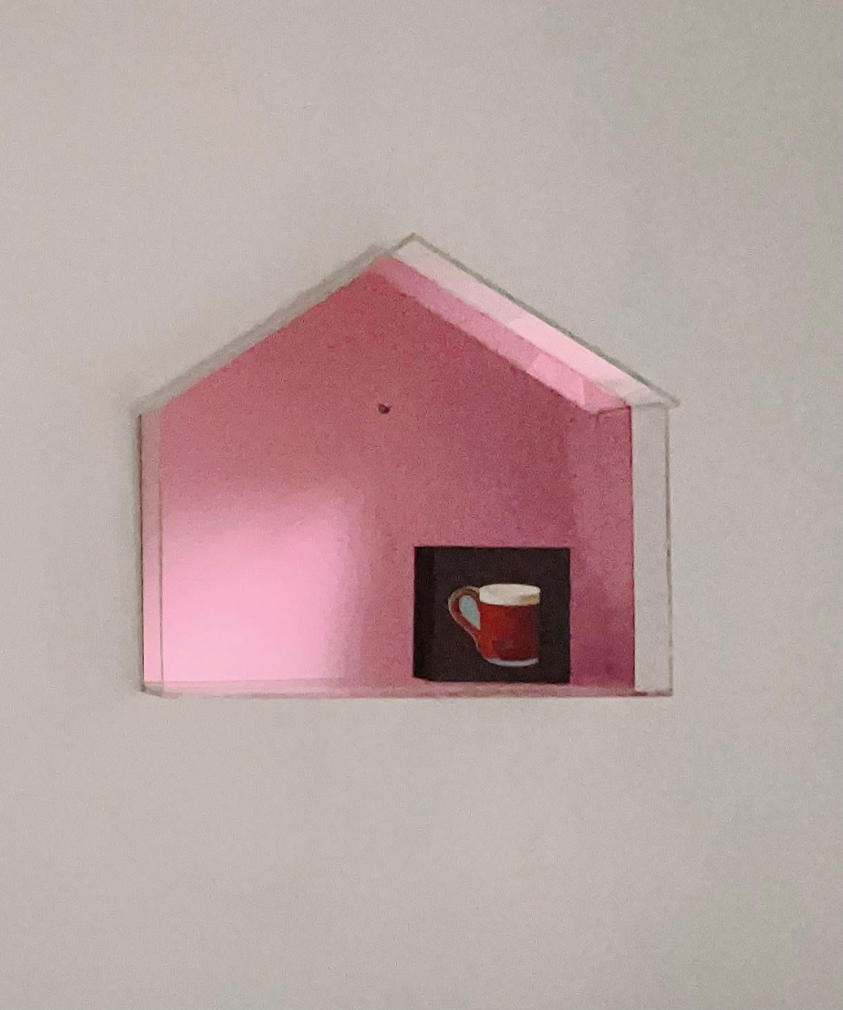 The structure of the artwork is made of plexiglass, shaped like a house. Inside the “house”, there’s a small painting depicting a mug. All hand crafted in Atlanta, GA.
The back panel is mirrored in pink color and it reflects the surrounding.