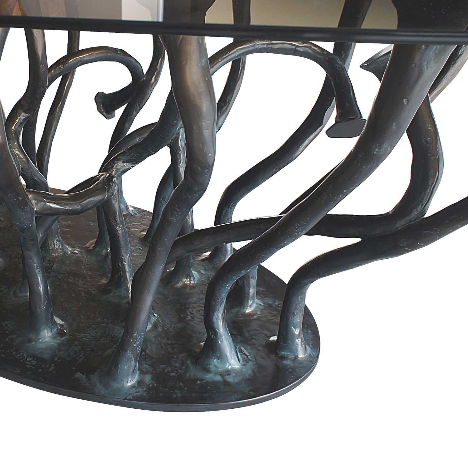 The design is inspired by tree branches that seem to emerge from the floor. The organic structure of the branches, which are washed to the surface, carries a smoked oval glass plate.
Custom sizes available upon request. 
We do our best to expedite