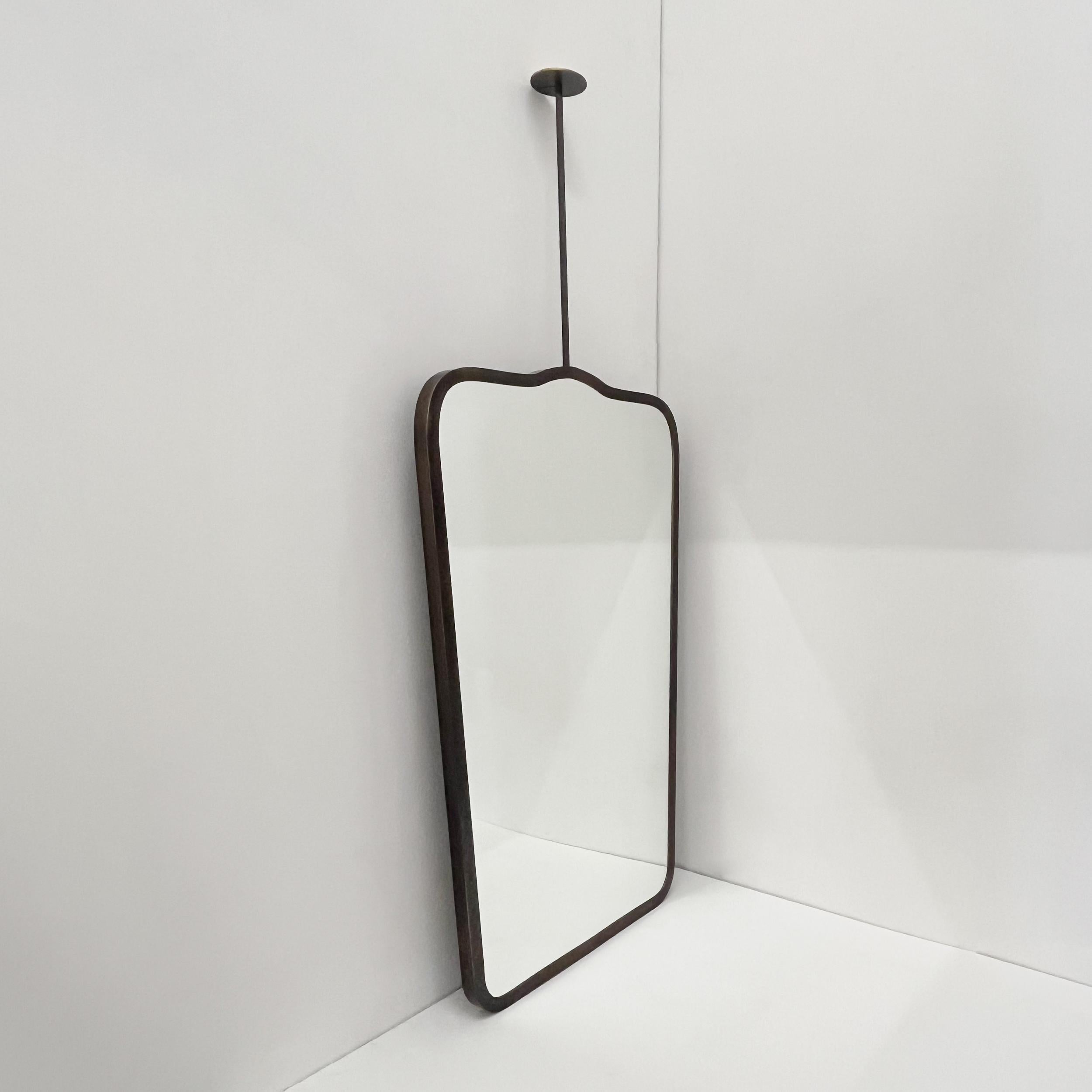 Available from stock.

Elegant ceiling suspended mirror with a high quality pure brass full frame with a bronze patina finish inspired by the celebrated work of Italian designer Gio Ponti. 

This piece is part of our original and fully customisable