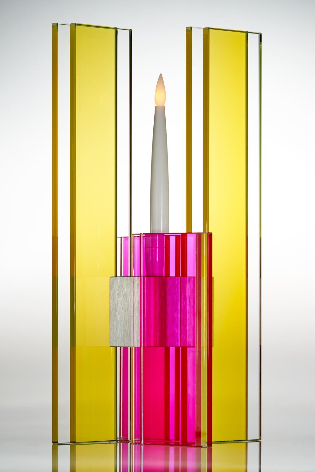 This polished glass candleholder from the Deco series is designed by world renowned glass artist, Sidney Hutter. With 40 years of experience in the contemporary glass and fine art world, Sidney now creates illuminated designs for the home. Create a