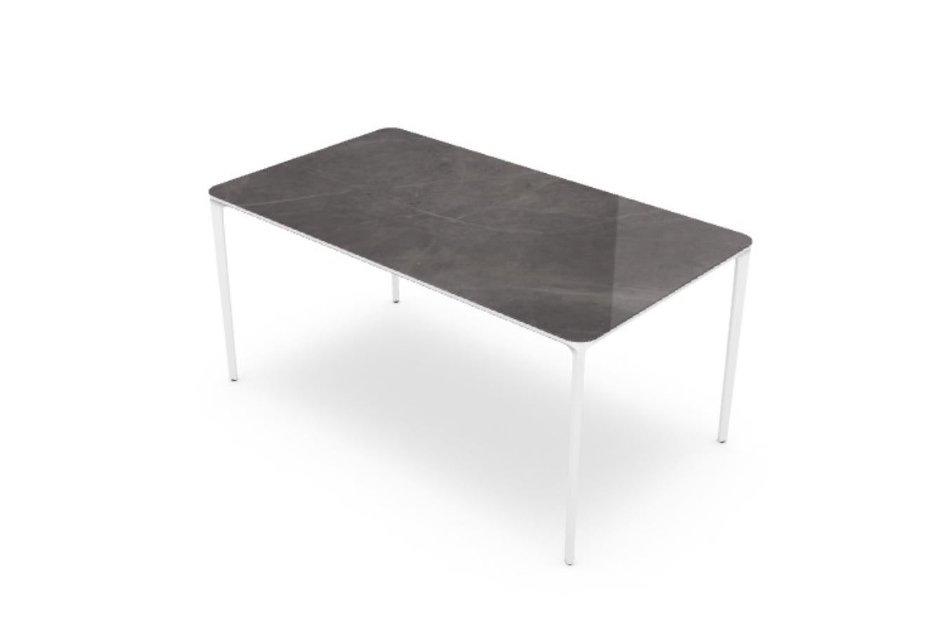 Slim outdoor ceramic dining table
In stock in Los Angeles

Dining table with die-cast aluminium legs, polished chrome finish or lacquered, various finishes, and anodized or lacquered, various finishes, aluminium structure profile. Tempered glass