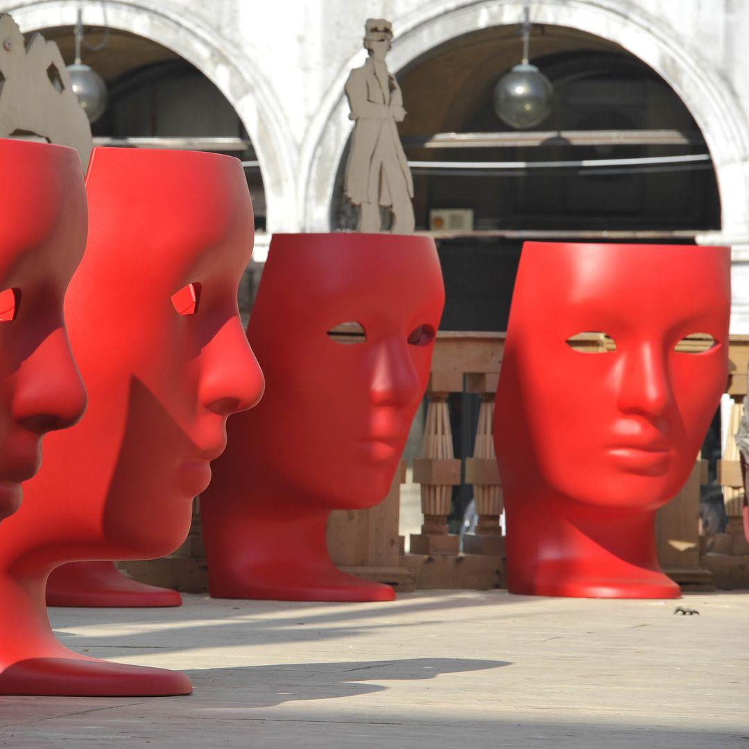 A life-size Greek mask becomes an inhabitable throne. The Nemo Swivel Armchair is carved from a single block of matte-black polyethylene, its classical profile turned outward while the hollowed interior cradles the sitter. Mounted on a hidden 360°