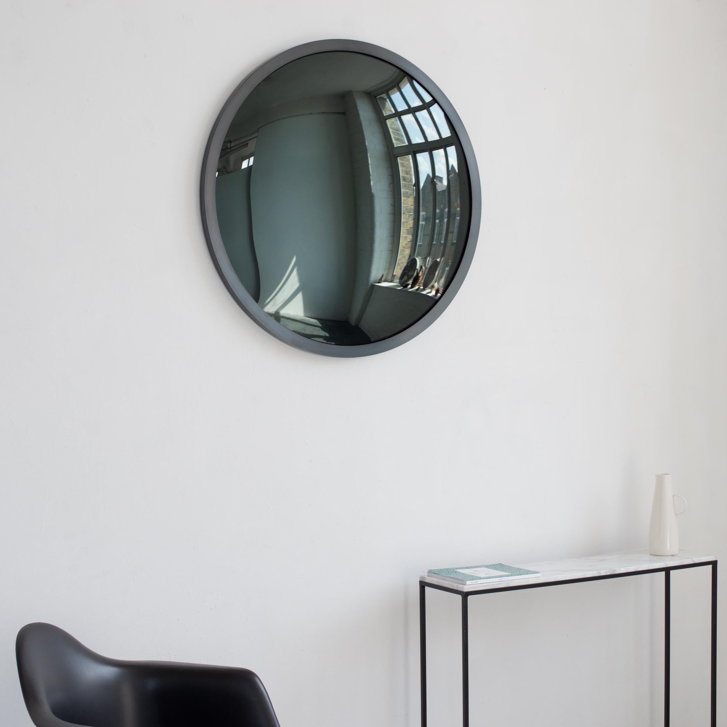 This mirror is available from stock.

Stunning convex black tinted mirror with a blackened metal full frame.

Each Orbis™ convex mirror is designed and handcrafted in London, UK. Slight variations in sizes and imperfections on edges and surface