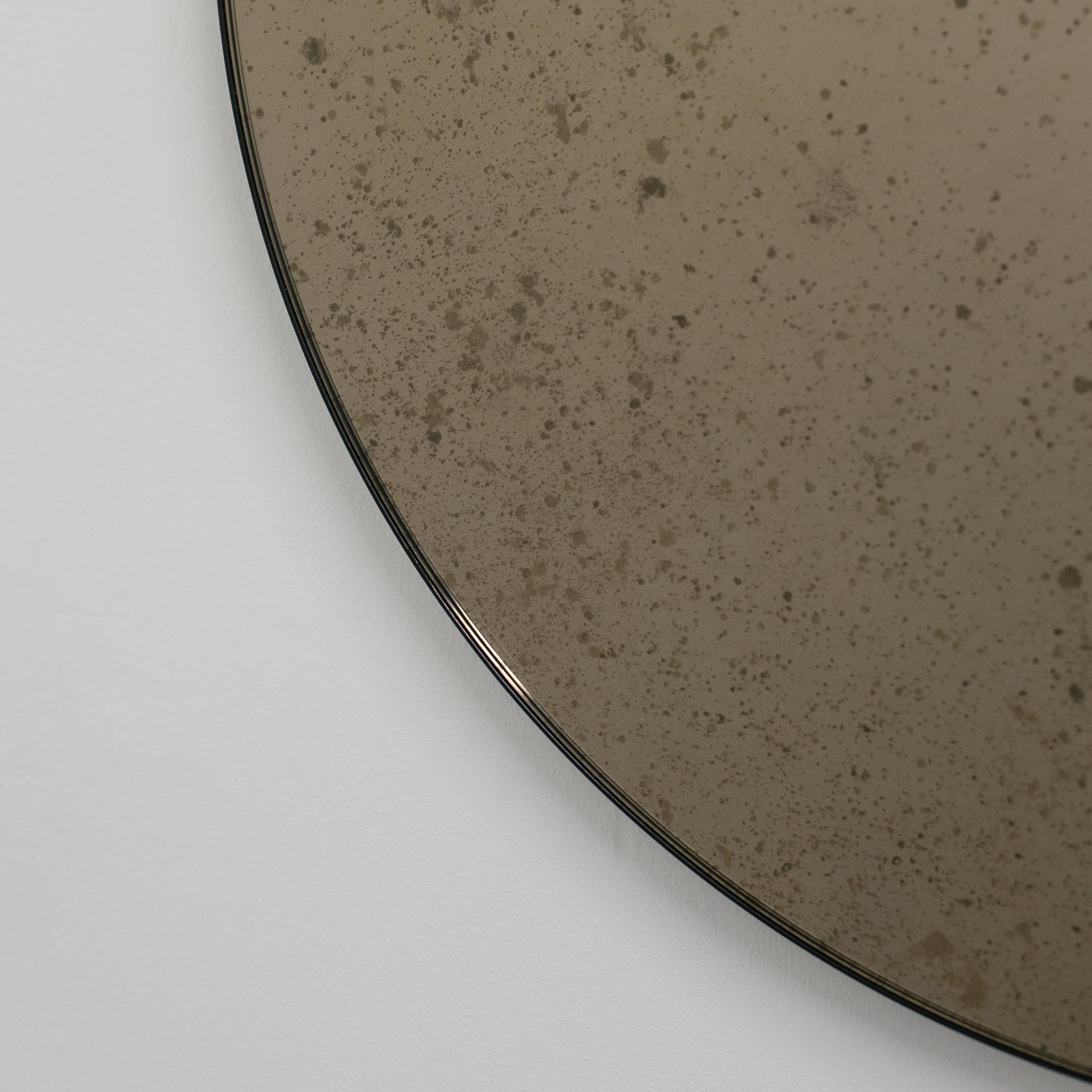 Powder-Coated In Stock, Orbis Round Bronze Antiqued Modernist Mirror with Black Frame, Medium For Sale