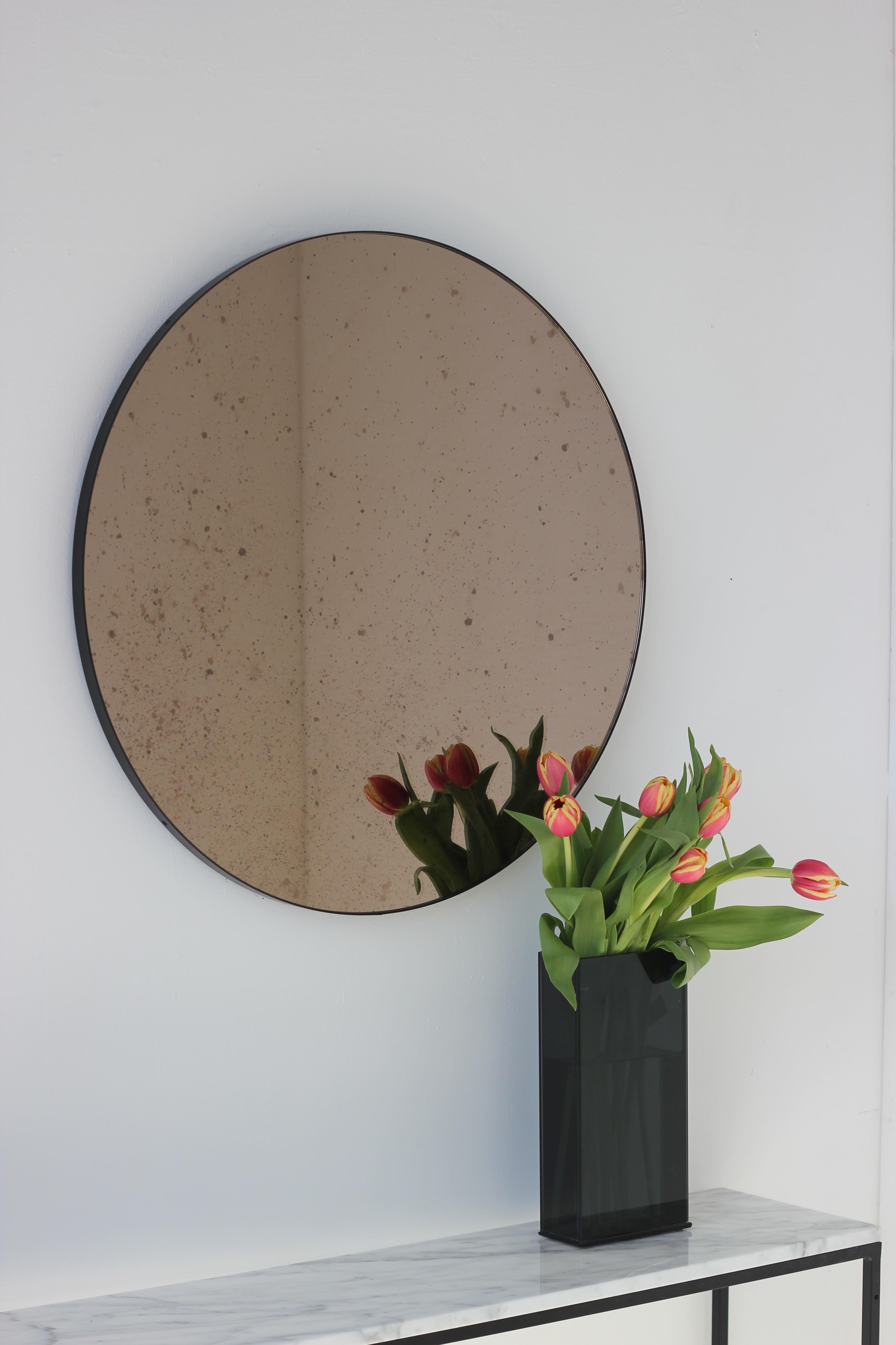 Contemporary In Stock, Orbis Round Bronze Antiqued Modernist Mirror with Black Frame, Medium For Sale