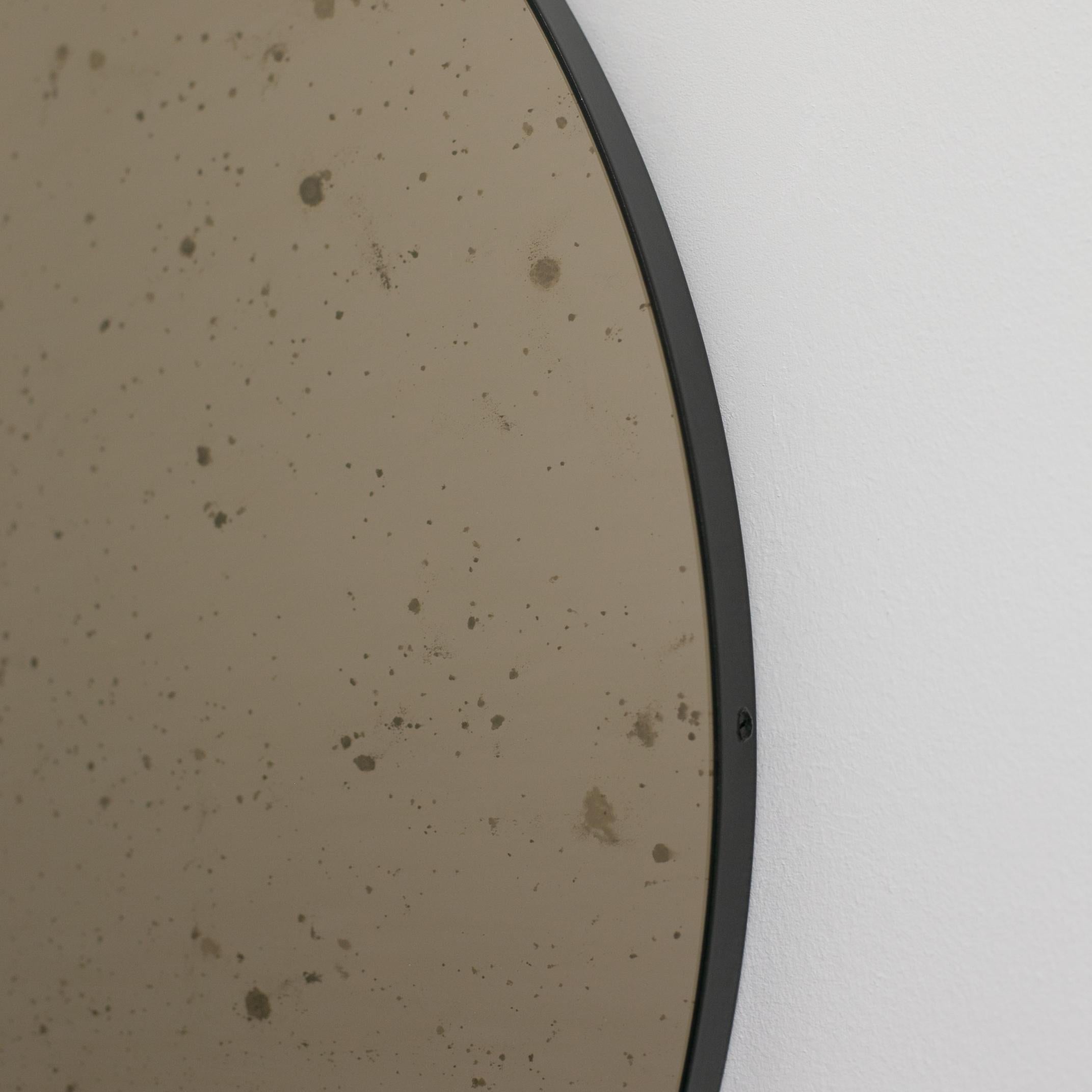 In Stock, Orbis Round Bronze Antiqued Modernist Mirror with Black Frame, Medium For Sale 1