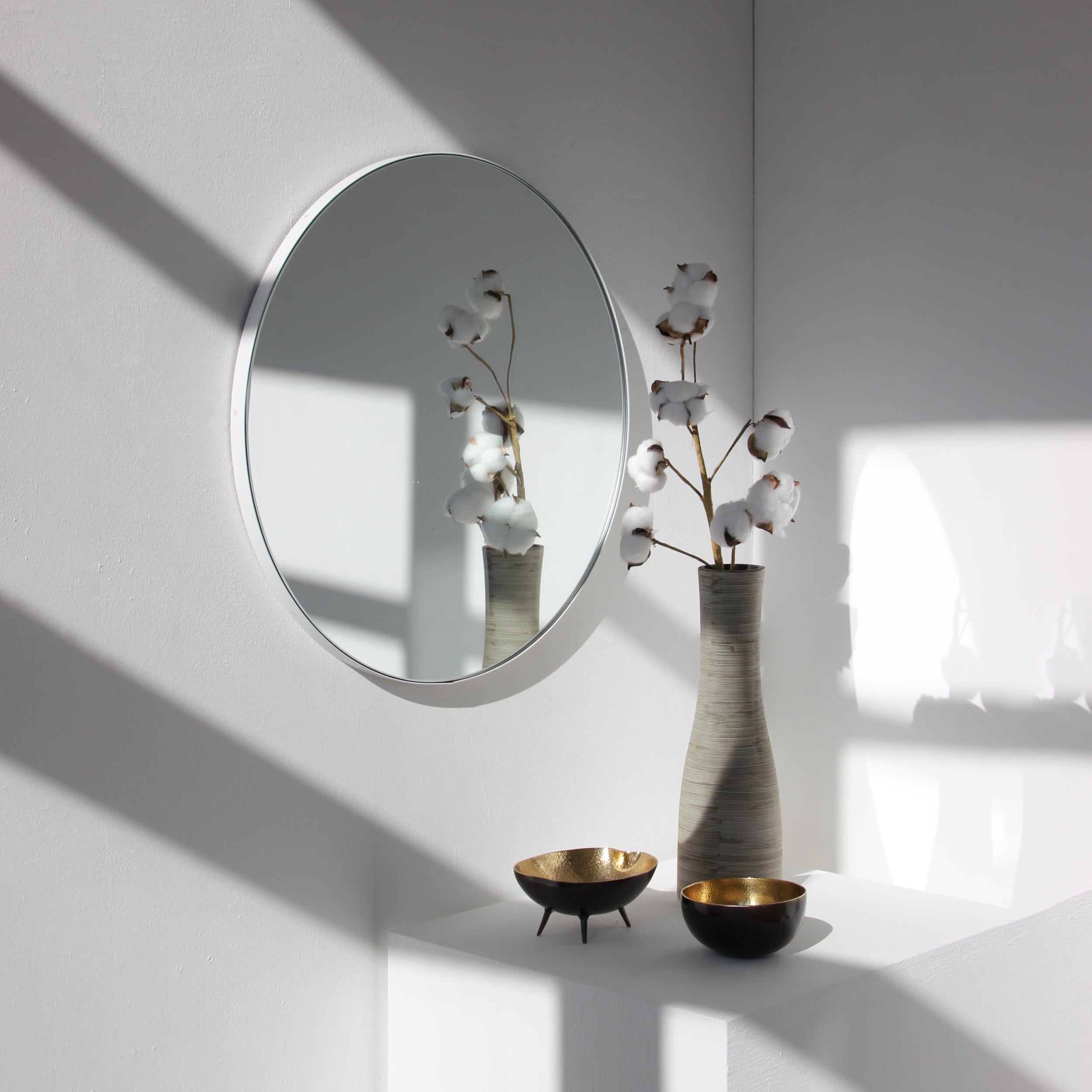 Minimalist round mirror with a smart white powder coated aluminium frame. Designed and handcrafted in London, UK. Measure: 80cm Diameter.

Fitted with a brass hook or an aluminium z-bar depending on the size of the mirror. Also available on demand