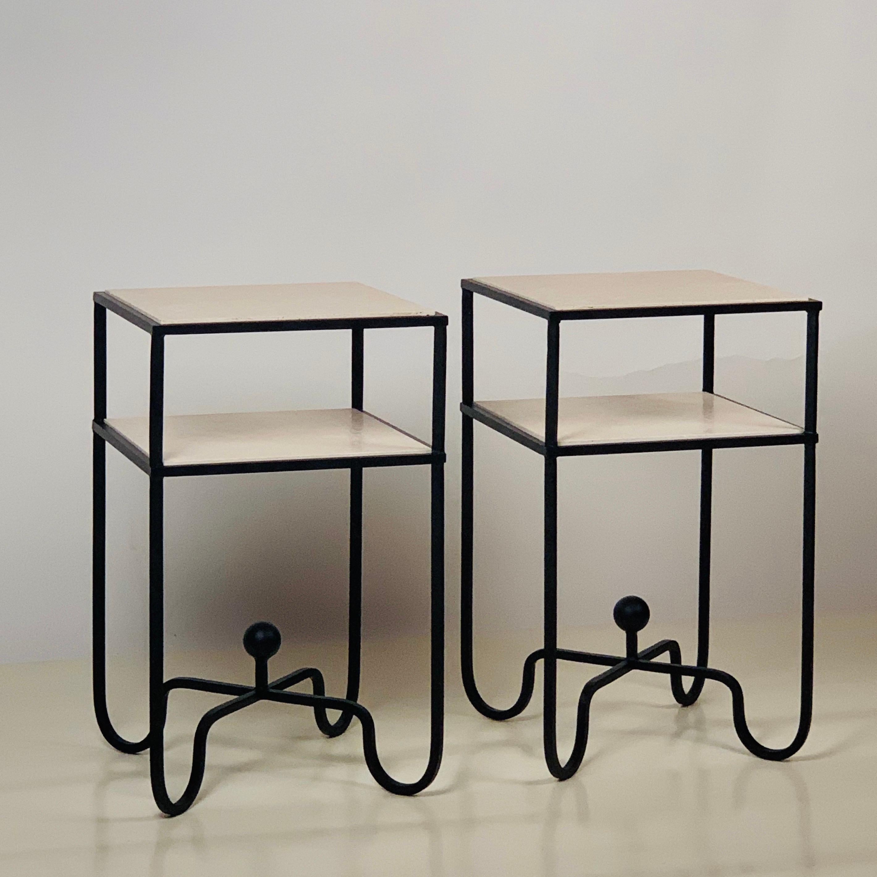In-Stock pair of 2-tier 'Entretoise' side tables by Design Frères. Wrought iron base with 2 thin cream travertine shelves. Also great as small nightstands. Shelves are removable for secure shipping and cleaning.

In stock now and ready to ship.