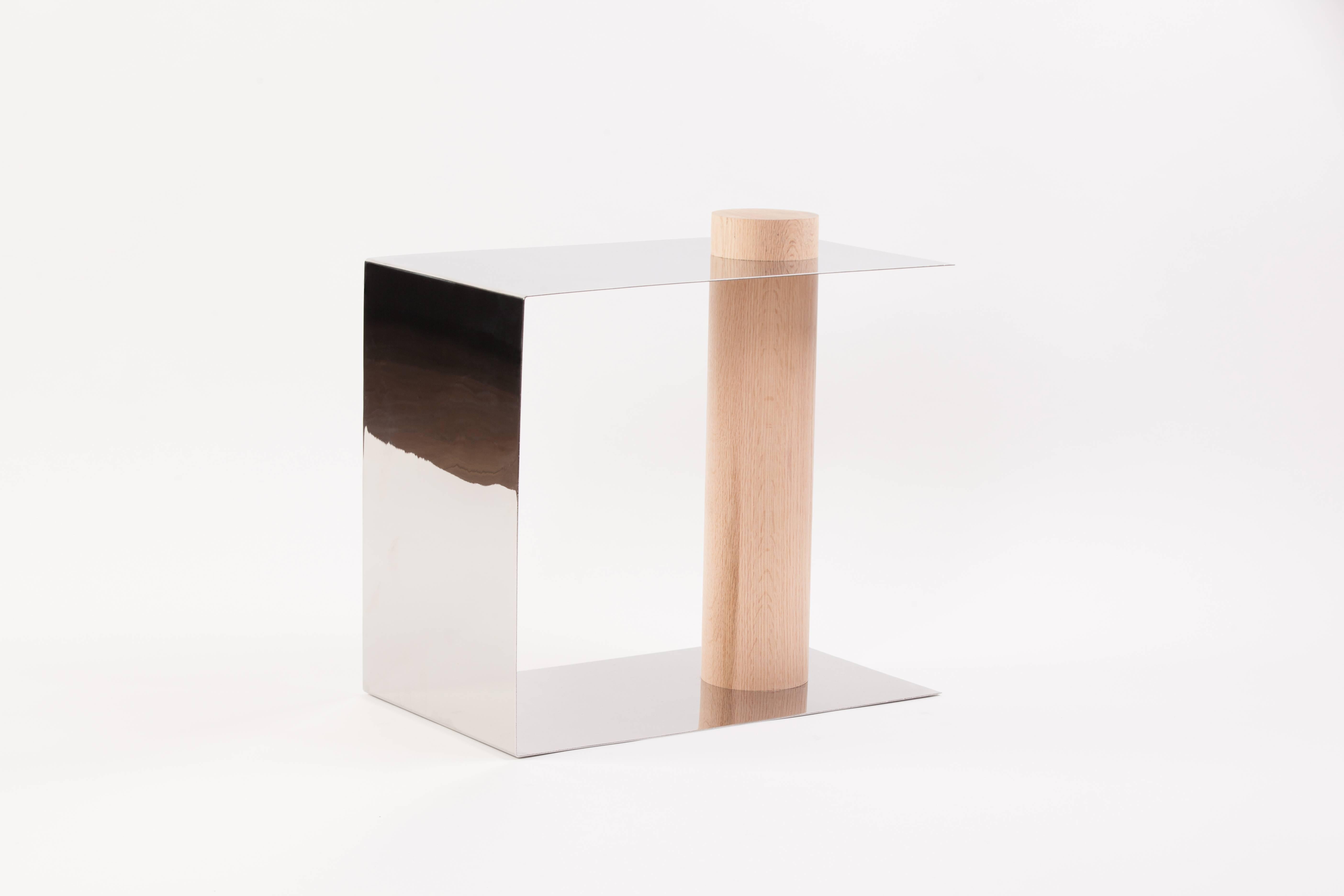 Puru is a modern side table, in mirrored polished stainless steel and white oak. The concept of the beauty of simplicity was the inspiration behind the Puru side table. Two elements are expressed by two materials. Deriving its name from the Japanese