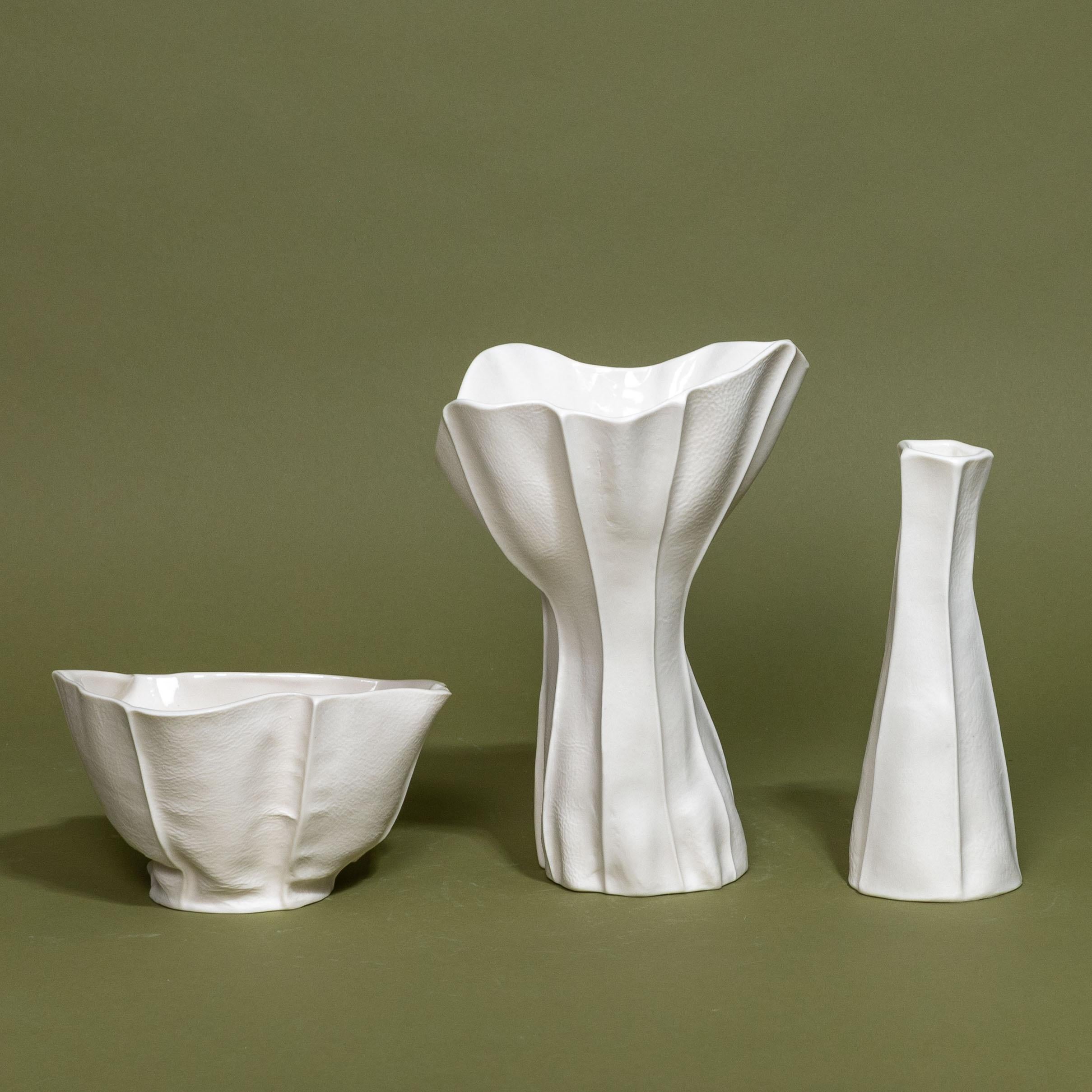 A grouping of one-of-a-kind Kawa Series items handcrafted by Luft Tanaka Studio by casting porcelain into sewn leather molds. 

Sold as a set of 3 items: 2 vases and a bowl. 

As a result of the production process, each item is one-of-a-kind. 

Tall
