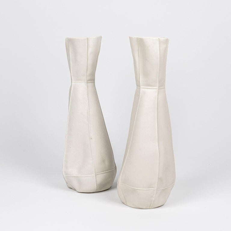 A tall porcelain flower vase with an organic and fabric-like surface. Clear glazed applied on interior surface. As a result of the production process each vase is one-of-a-kind. 

Dimensions
5