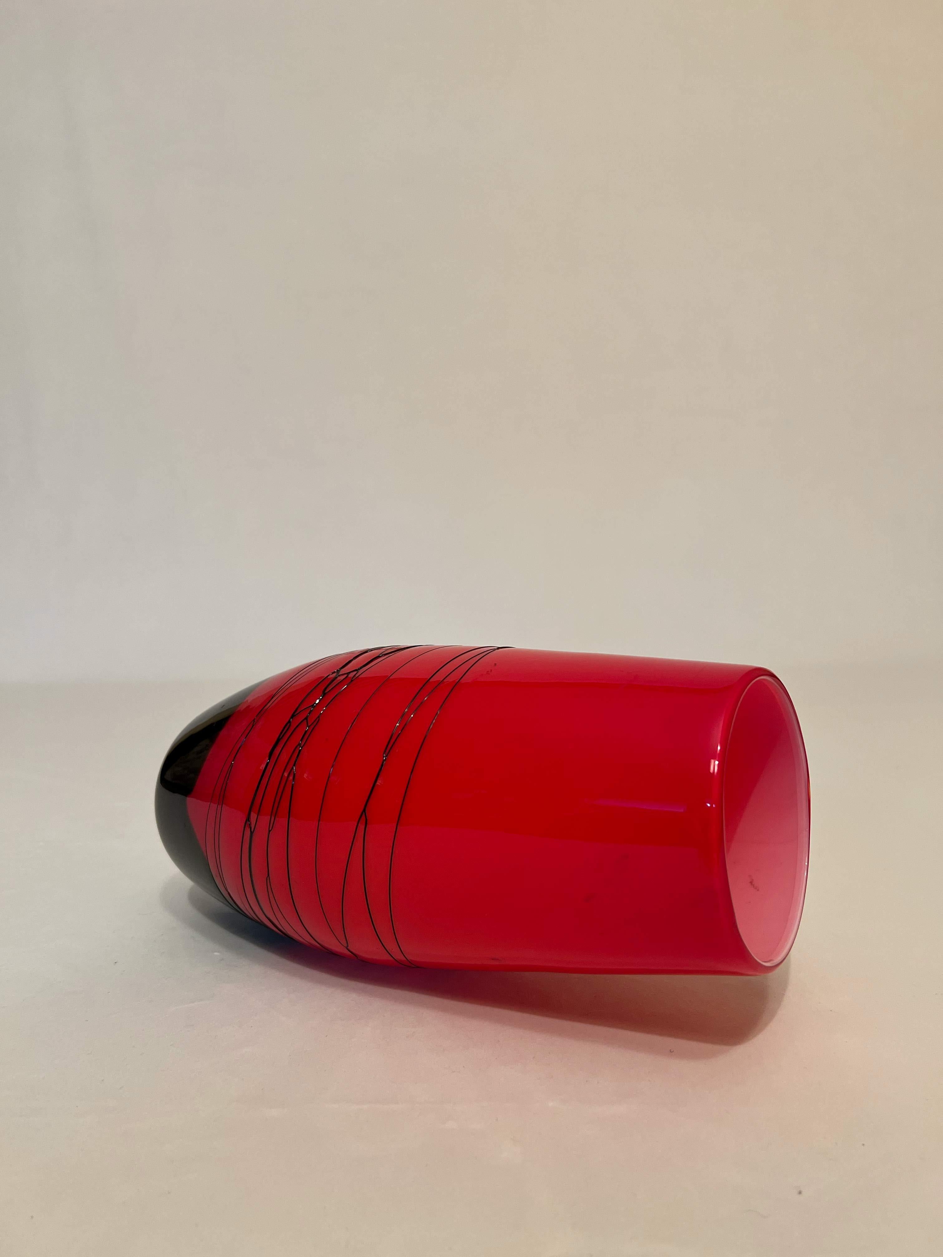 Vase in carmine red glass and black resin from the 1980s from the personal collection of a Sicilian family. Vase in bright tones suitable for any environment to enrich, and warm, the rooms of your home. 

Gaetano Pesce studied architecture at the