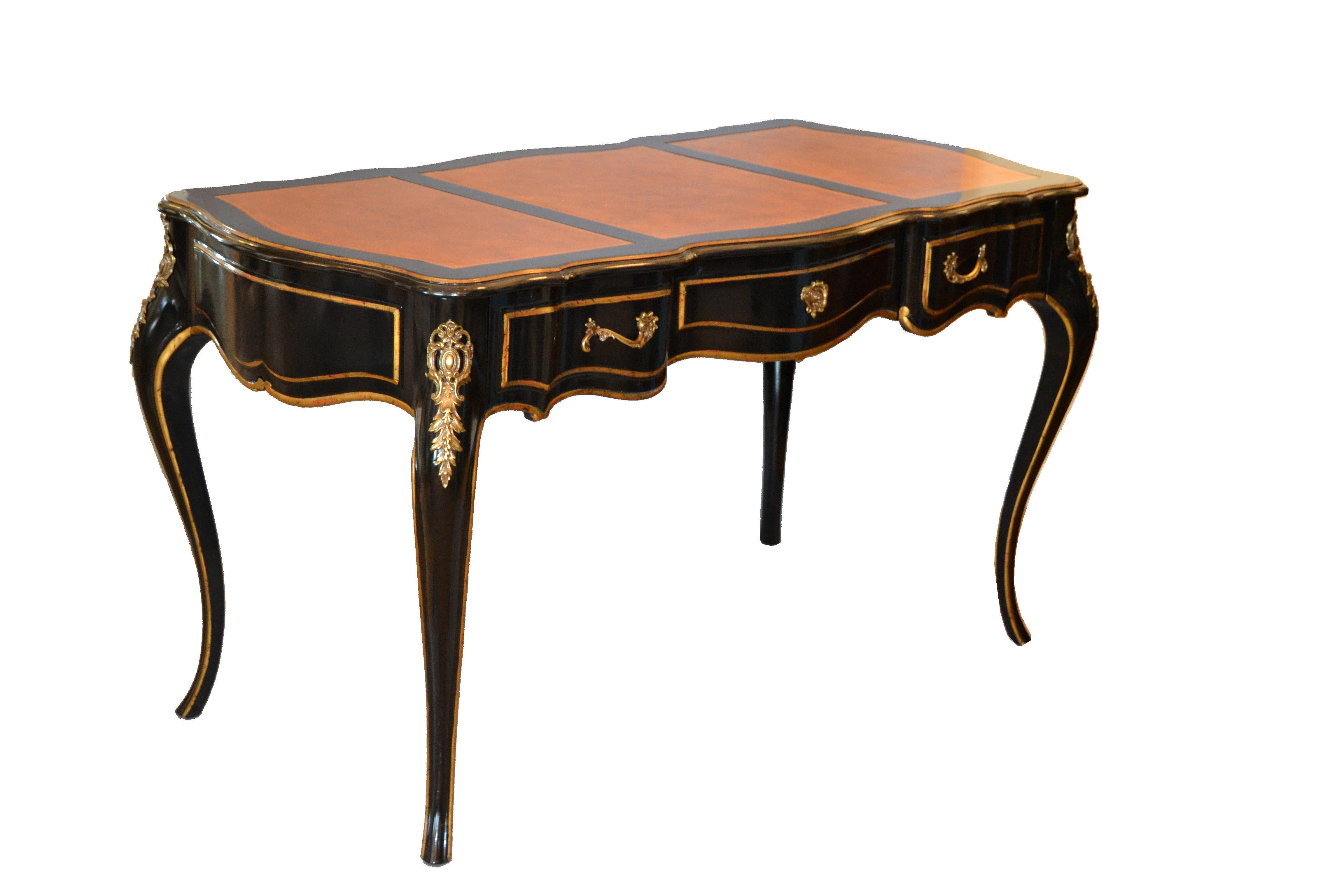 Graceful writing desk by Drexel in ebonized wood and a light brown three part leather top.
In the style of Louis XV, comes with matching stool.
Features three dovetailed drawers with pencil trays and bronze hardware.
Marked inside the drawer.
 
