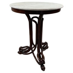In the manner of J&J Kohn, bentwood and marble side table. 