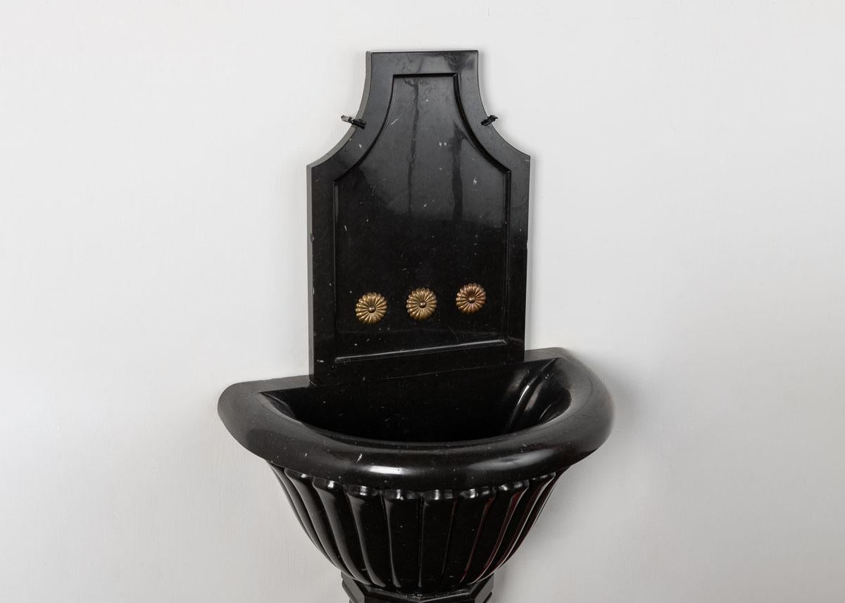 This 1920s indoor wall-mounted fountain features carved copper details in the shape of daisies. In the manner of French Art Deco designers Süe et Mare.