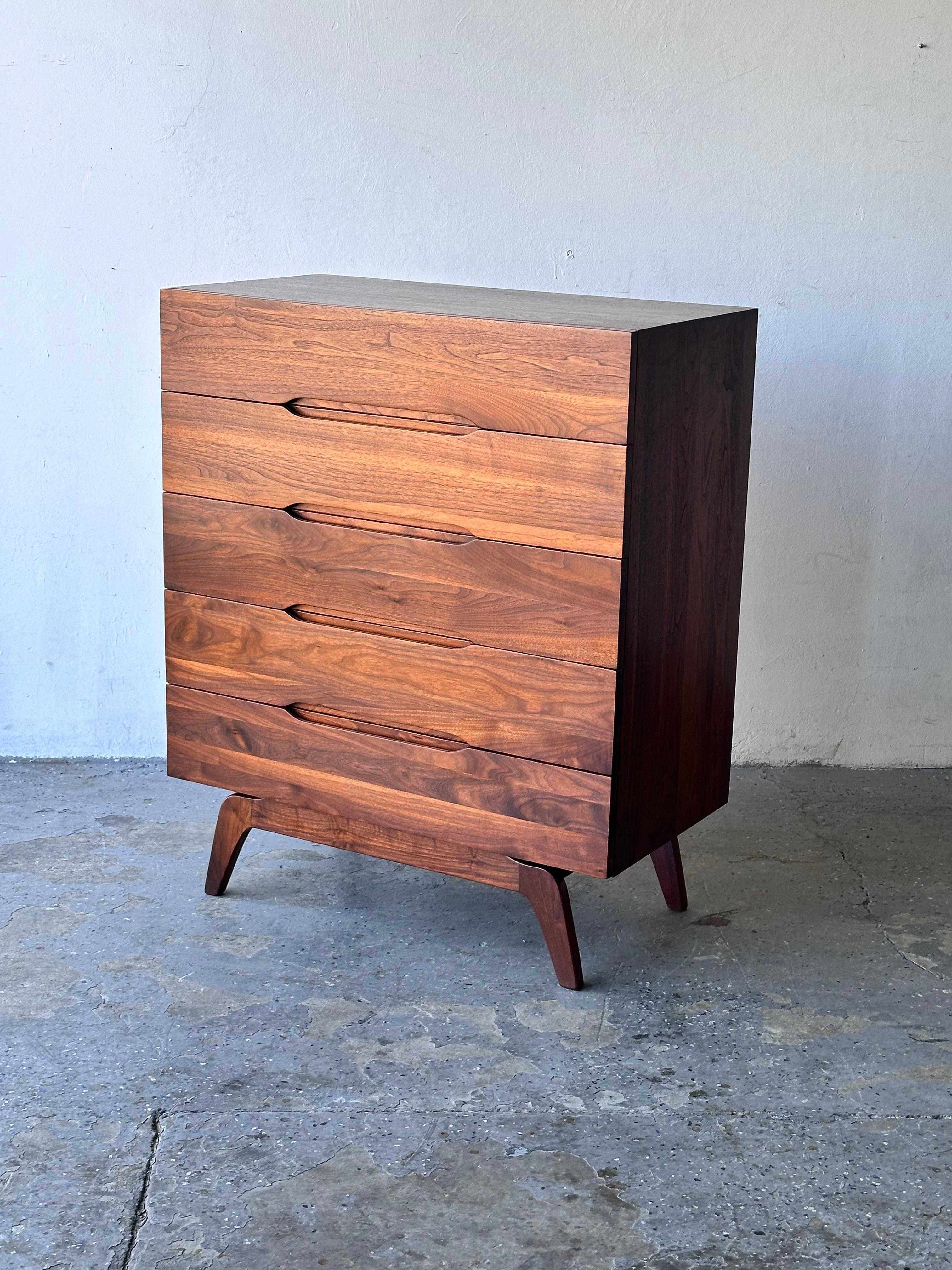 Solid walnut drawer faces with beautiful sculpted drawer pulls. Splayed leg design, reminiscent of Vladimir Kagan’s and Arne Vodder designs. Beautiful walnut grain in excellent vintage condition. Professionally restored. 

Most Mid Century Furniture